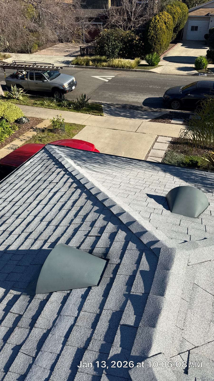Gray asphalt shingle roof with two plumbing vent boots installed | Roof Replacement Inc Gray asphalt shingle roof with two plumbing vent boots installed — Roof Replacement Inc