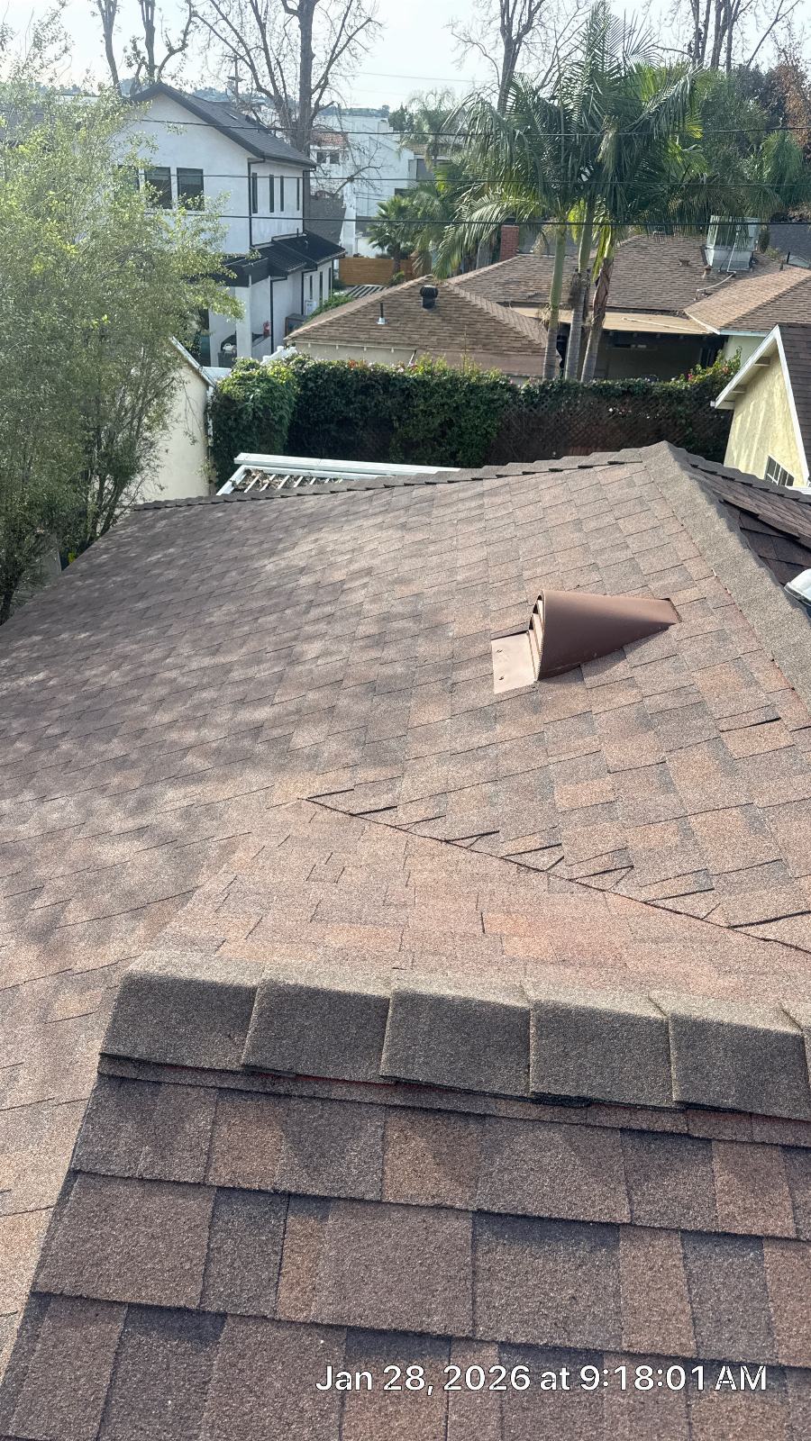 Asphalt shingle roof with brown exhaust vent stack, suburban neighborhood | Roof Replacement Inc Asphalt shingle roof with brown exhaust vent stack, suburban neighborhood — Roof Replacement Inc