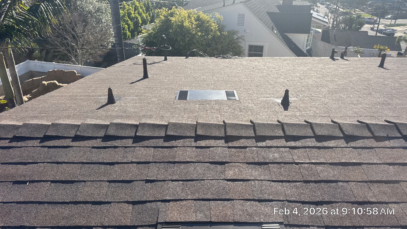 Asphalt shingle roof with pipe boots, attic vent, and ridge cap. | Roof Replacement Inc Asphalt shingle roof with pipe boots, attic vent, and ridge cap. — Roof Replacement Inc