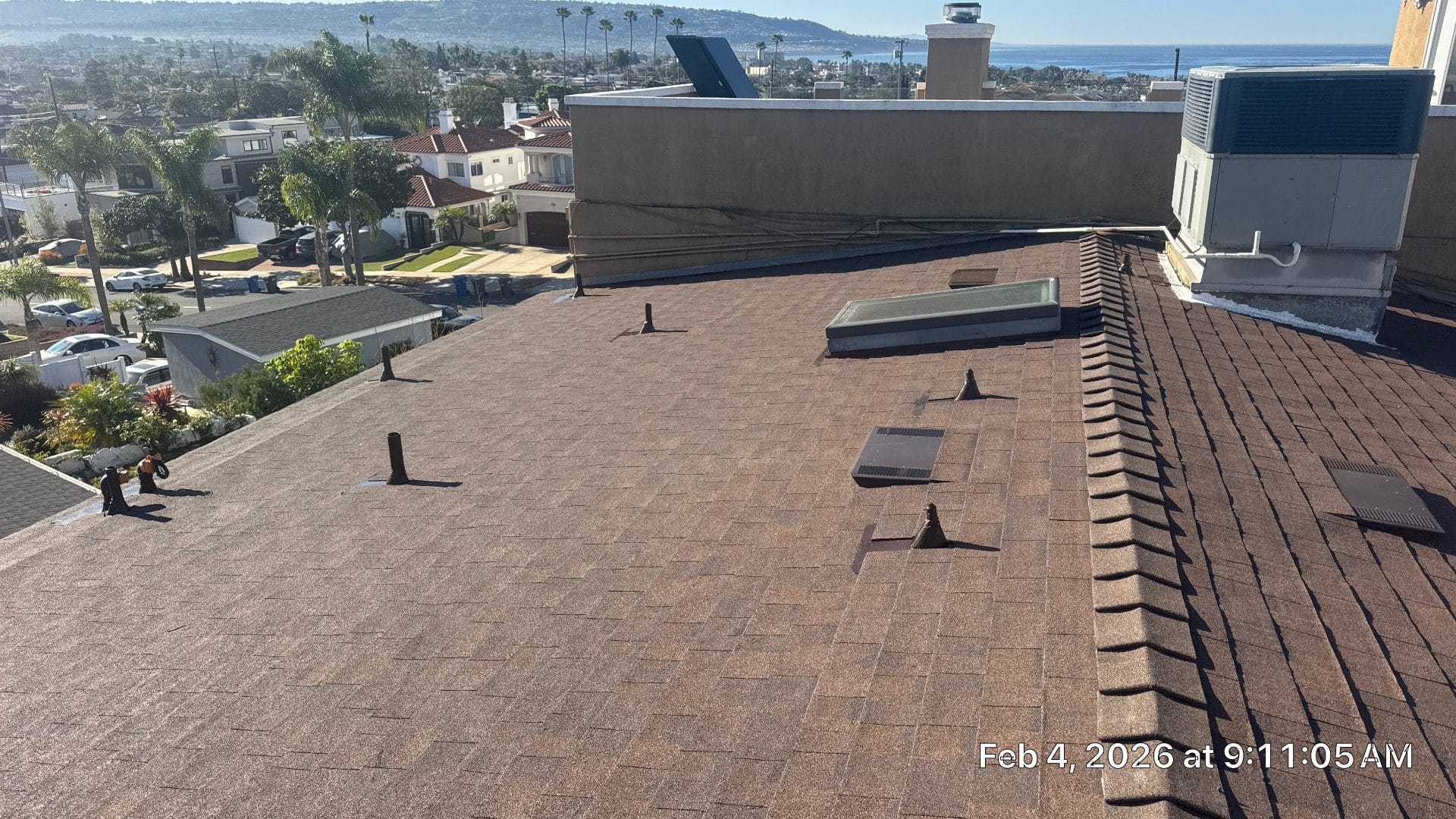 Brown asphalt shingle roof with pipe boots, skylight, vent, HVAC unit | Roof Replacement Inc Brown asphalt shingle roof with pipe boots, skylight, vent, HVAC unit — Roof Replacement Inc