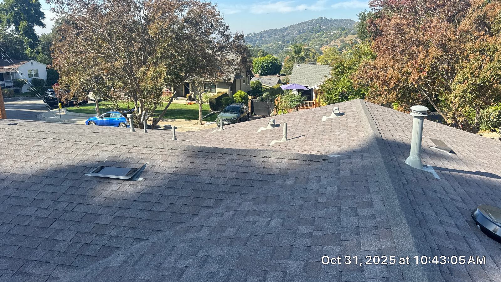Gray asphalt shingle roof with pipe boots, attic vent, and cap vent. — Roof Replacement Inc