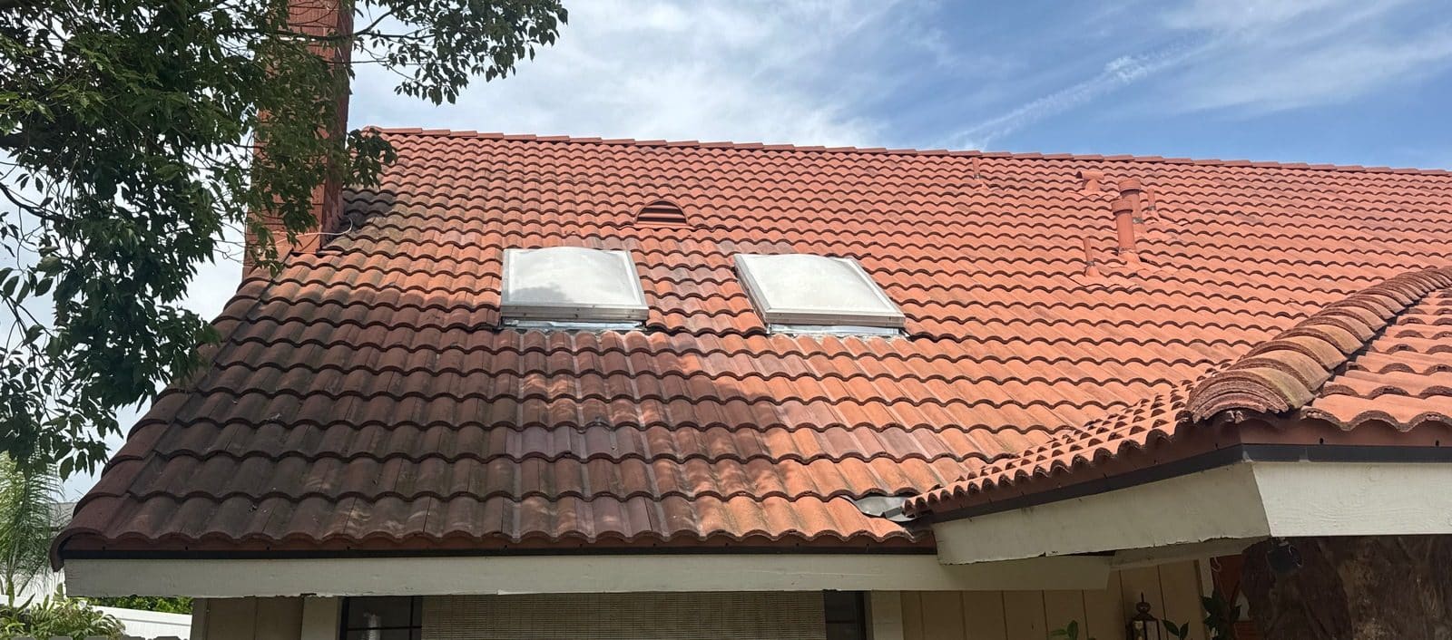 terracotta barrel tile roof with two skylights and roof vent — Roof Replacement Inc