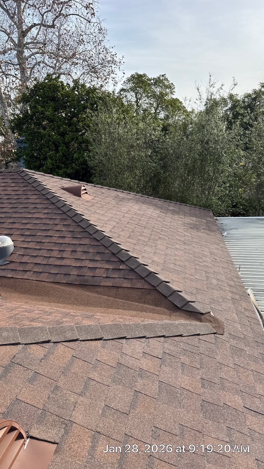 Brown asphalt shingle roof with hip ridge and pipe vents | Roof Replacement Inc Brown asphalt shingle roof with hip ridge and pipe vents — Roof Replacement Inc