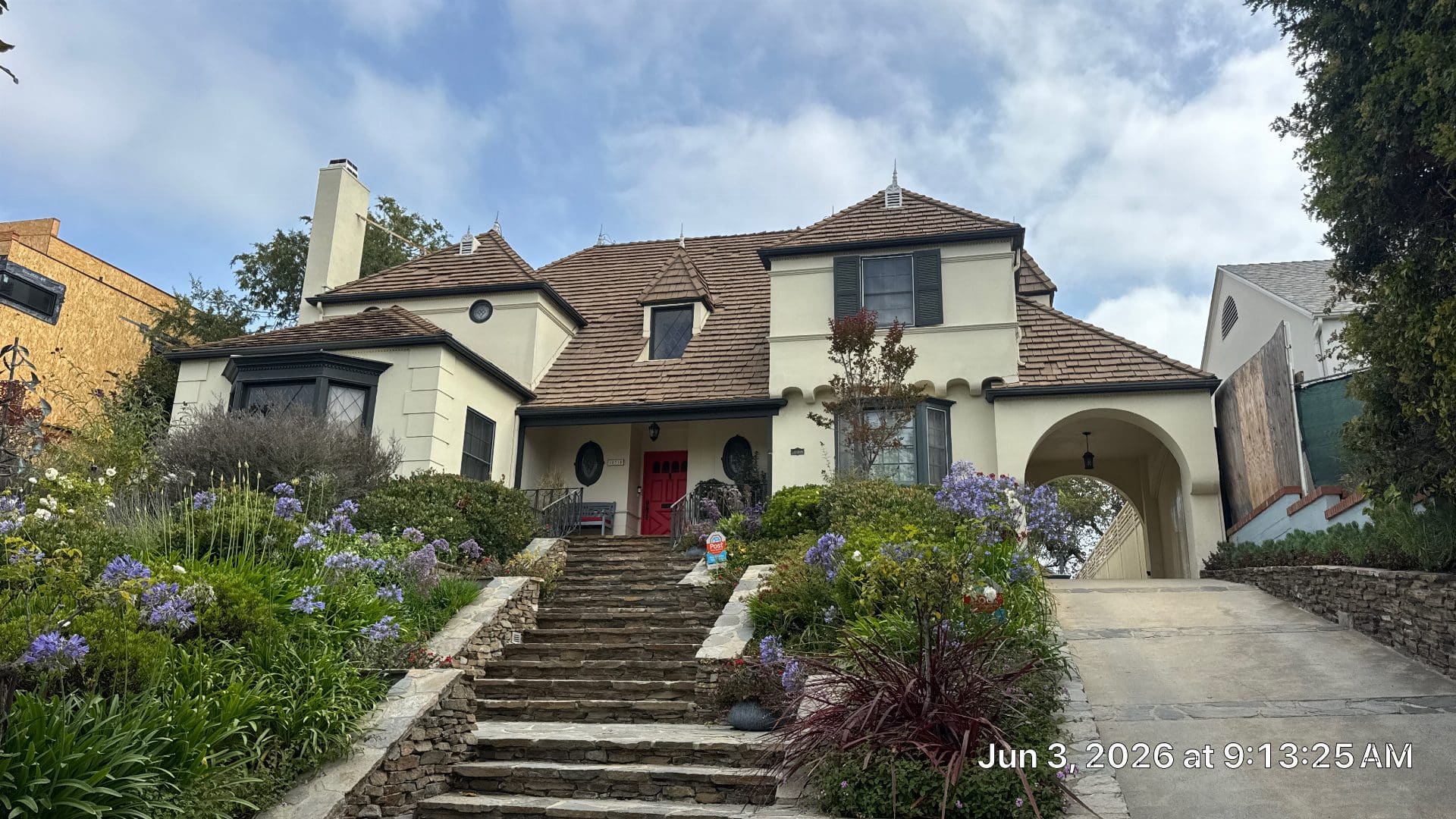 White stucco home with brown cedar shake roof, arched entry | Roof Replacement Inc White stucco home with brown cedar shake roof, arched entry — Roof Replacement Inc