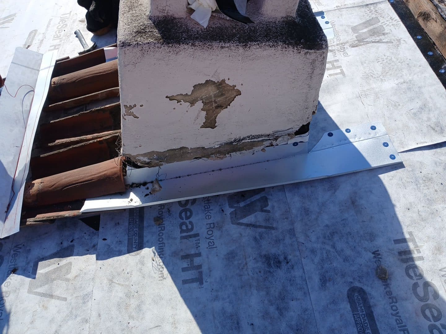 Chimney base with new aluminum flashing on underlayment, exposed wood battens. | Roof Replacement Inc Chimney base with new aluminum flashing on underlayment, exposed wood battens. — Roof Replacement Inc