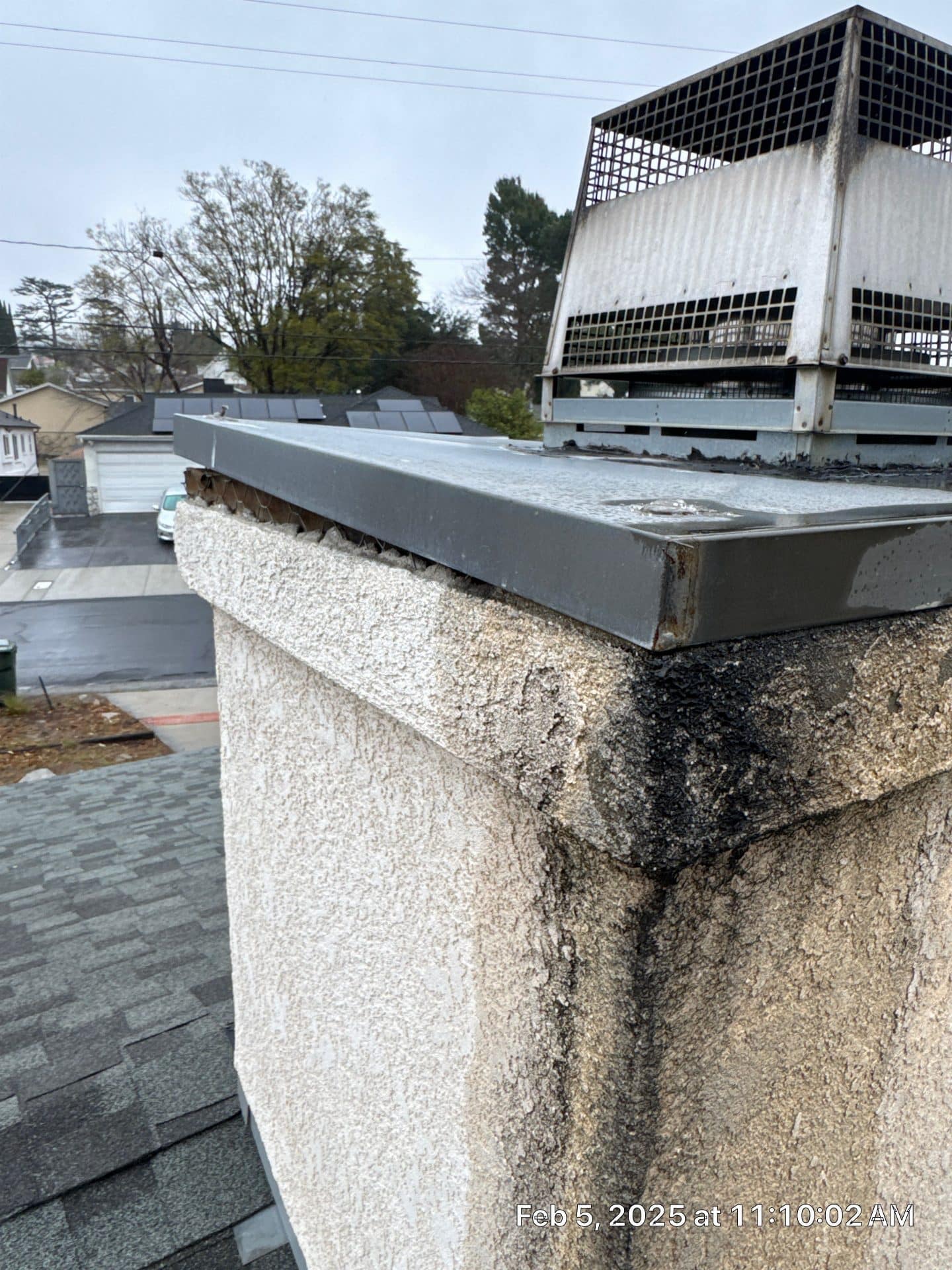 Cracked stucco chimney with metal cap and creosote staining in La Crescenta-Montrose | Roof Replacement Inc cracked stucco chimney with metal cap and creosote staining — La Crescenta-Montrose — Roof Replacement Inc