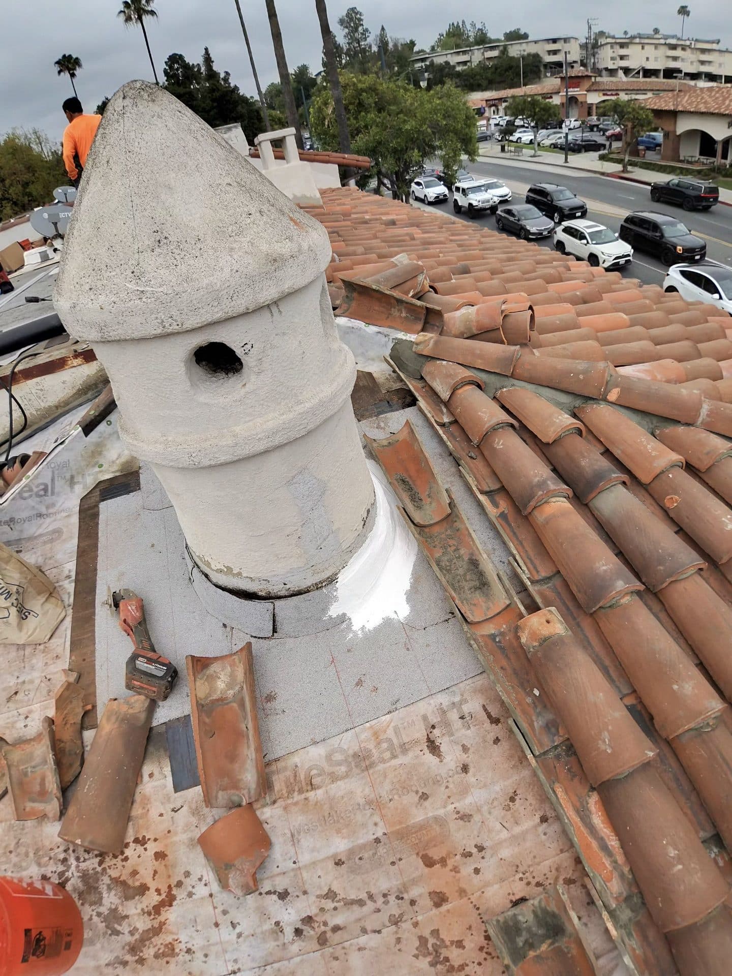 Clay tile roof repair; decorative chimney pot, underlayment exposed, loose tiles | Roof Replacement Inc Clay tile roof repair; decorative chimney pot, underlayment exposed, loose tiles — Roof Replacement Inc