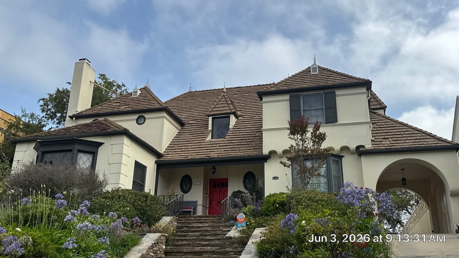 Two-story stucco home with brown clay tile roof, multiple hips and dormers | Roof Replacement Inc Two-story stucco home with brown clay tile roof, multiple hips and dormers — Roof Replacement Inc
