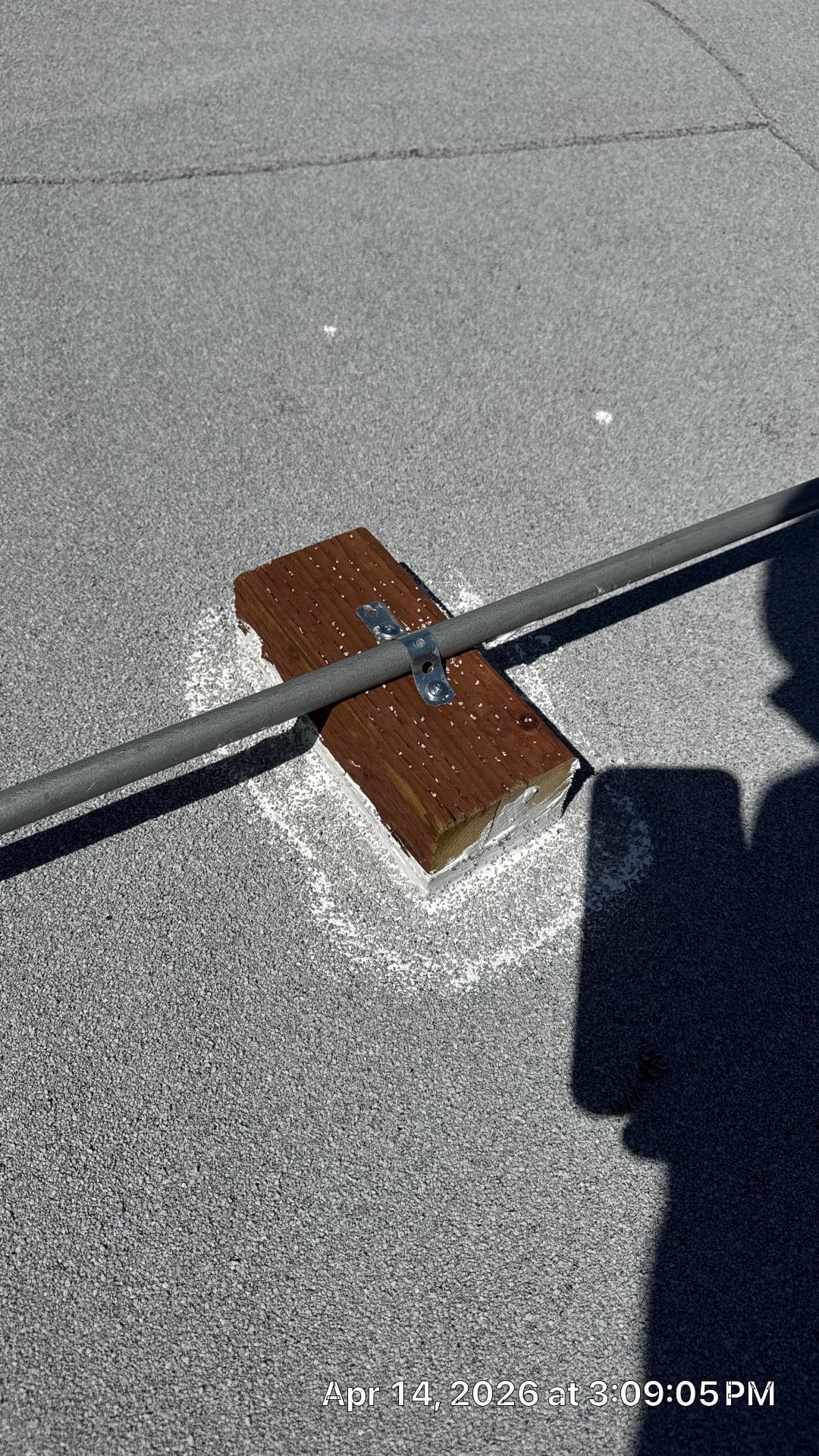 metal conduit secured to wood block on flat gravel roof — La Cañada Flintridge — Roof Replacement Inc