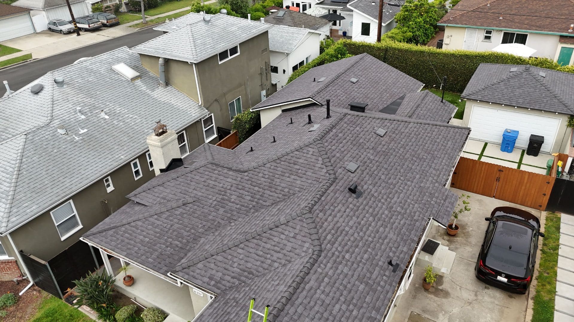 Aerial view of completed dark gray asphalt shingle hip roof with vents — Roof Replacement Inc