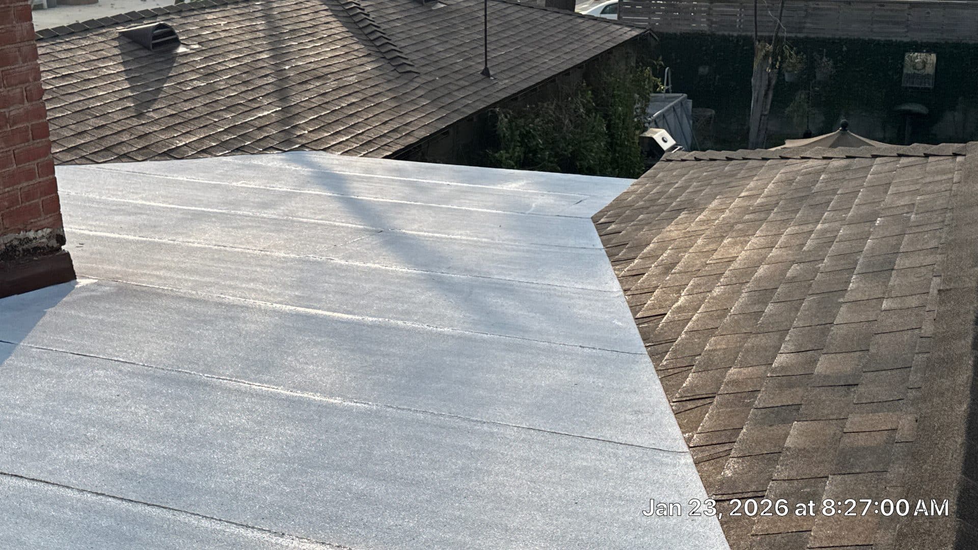 Flat modified bitumen roof beside asphalt shingle sloped roof in Burbank | Roof Replacement Inc flat modified bitumen roof beside asphalt shingle sloped roof — Burbank — Roof Replacement Inc