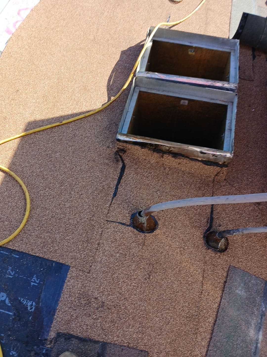 Flat roof underlayment with open skylight curb and pipe penetrations — Roof Replacement Inc