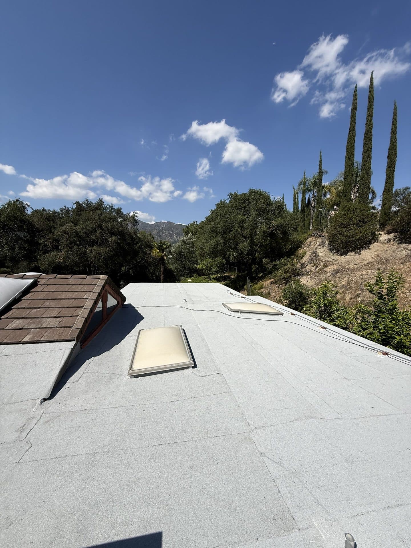 Flat white membrane roof with two skylights and wood dormer in La Cañada Flintridge | Roof Replacement Inc flat white membrane roof with two skylights and wood dormer — La Cañada Flintridge — Roof Replacement Inc