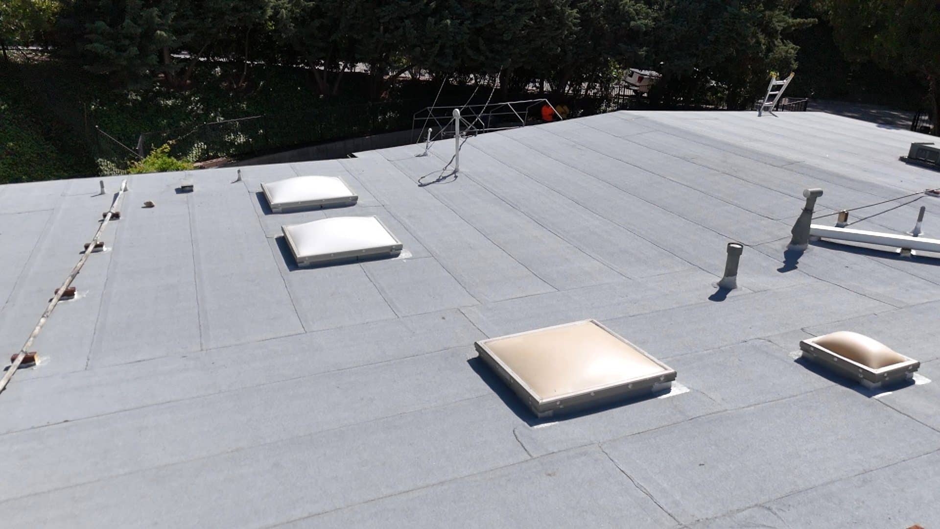 Flat roof with multiple skylights and rooftop vents, modified bitumen membrane in La Cañada Flintridge | Roof Replacement Inc flat roof with multiple skylights and rooftop vents, modified bitumen membrane — La Cañada Flintridge — Roof Replacement Inc