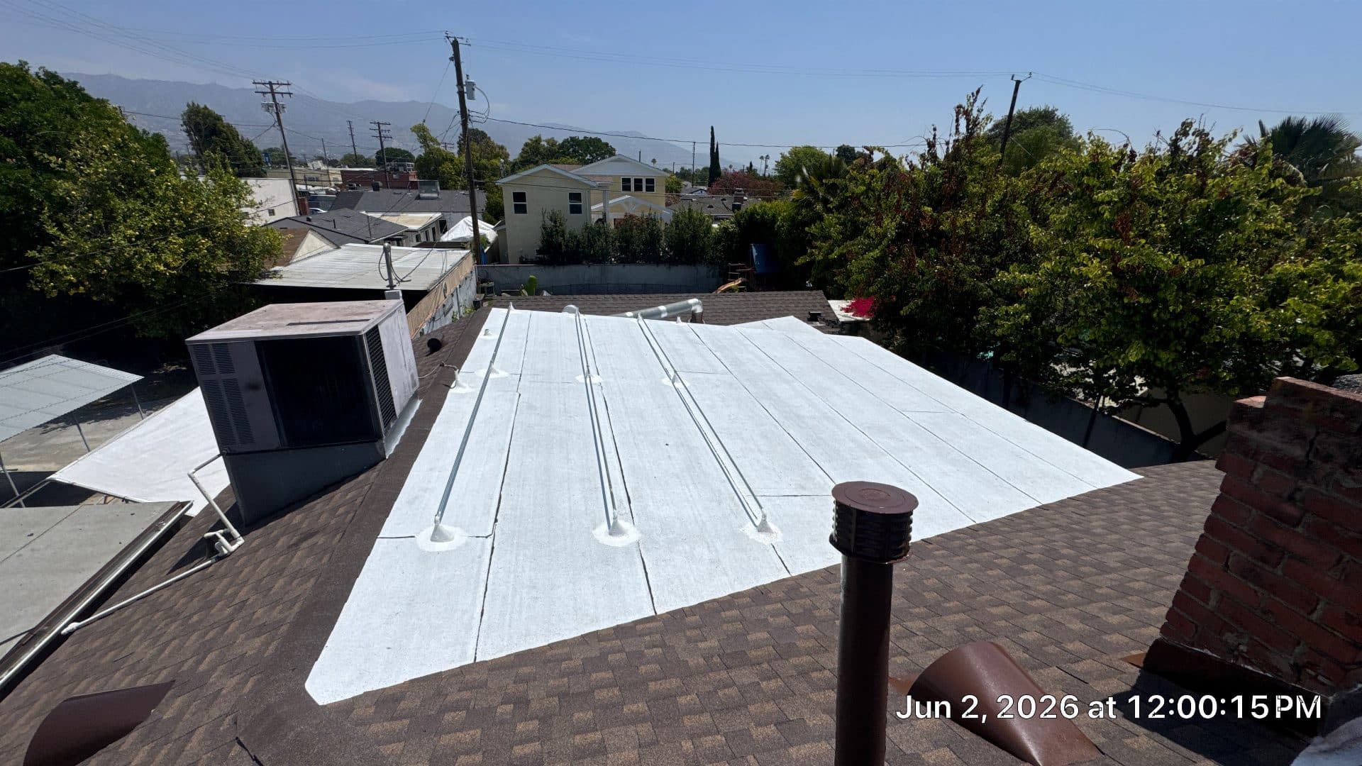 White underlayment membrane laid over flat roof with pipe penetrations | Roof Replacement Inc White underlayment membrane laid over flat roof with pipe penetrations — Roof Replacement Inc