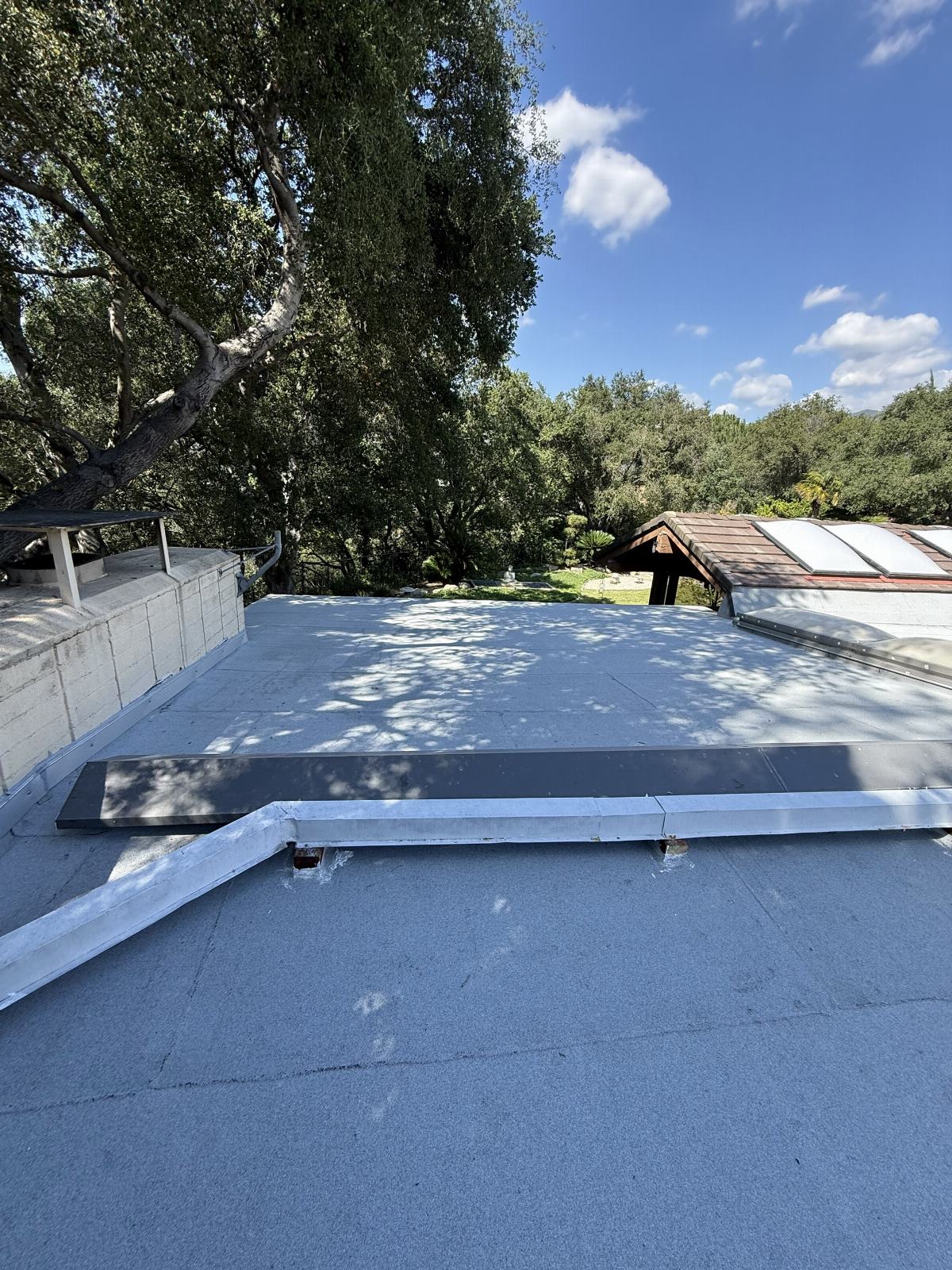 flat roof with white membrane, skylights, and open skylight frame — La Cañada Flintridge — Roof Replacement Inc