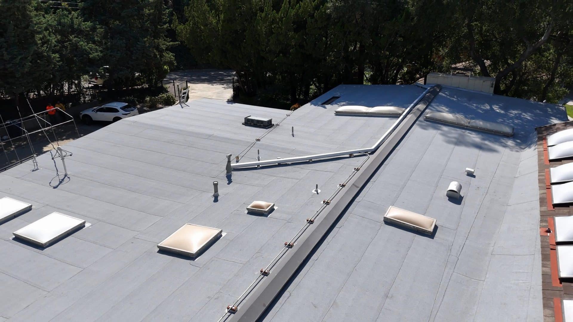 flat TPO roof with skylights, HVAC unit, pipe vents, and lightning protection — La Cañada Flintridge — Roof Replacement Inc