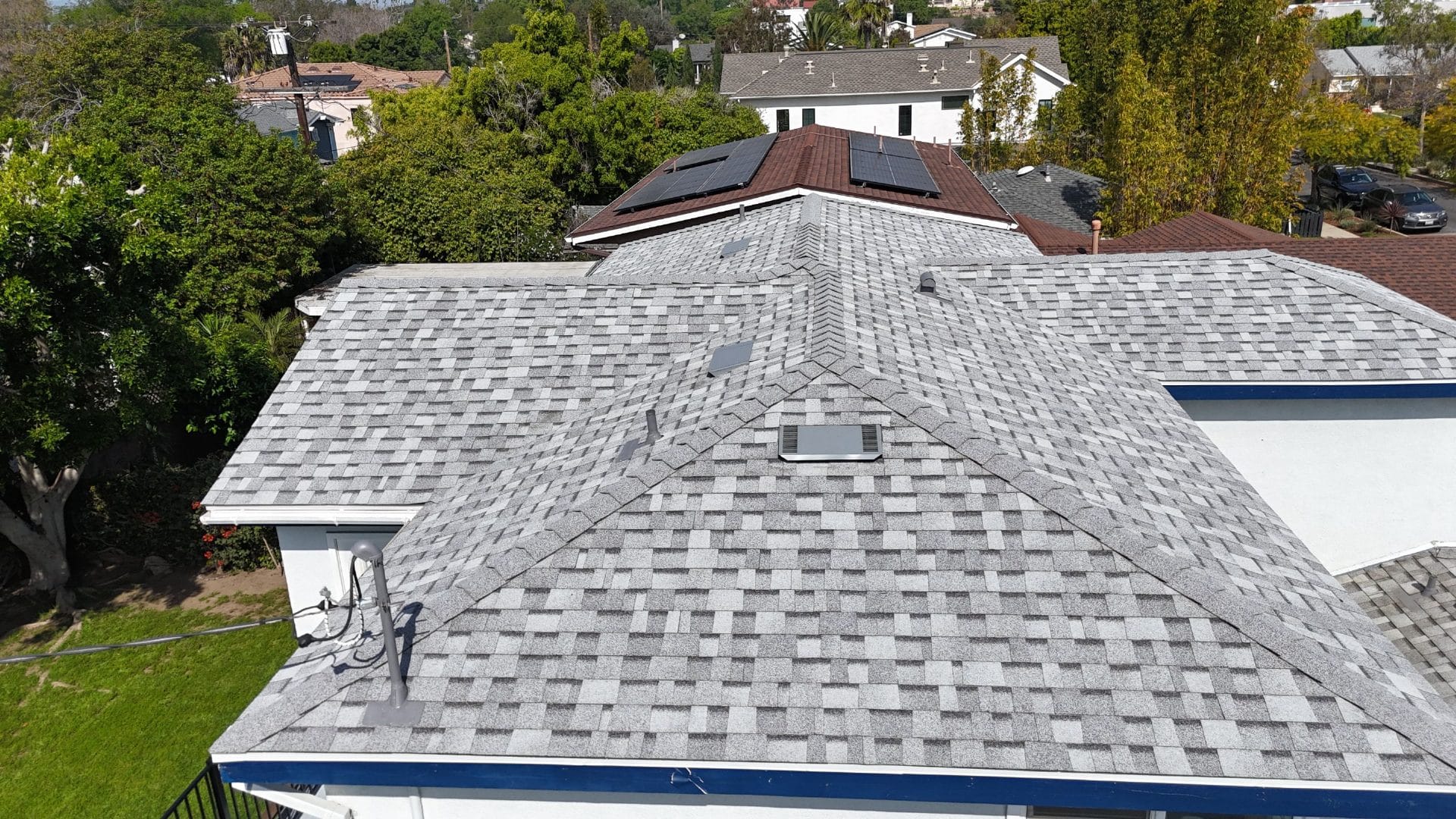 Gray asphalt shingle hip roof with skylight and roof vents | Roof Replacement Inc Gray asphalt shingle hip roof with skylight and roof vents — Roof Replacement Inc