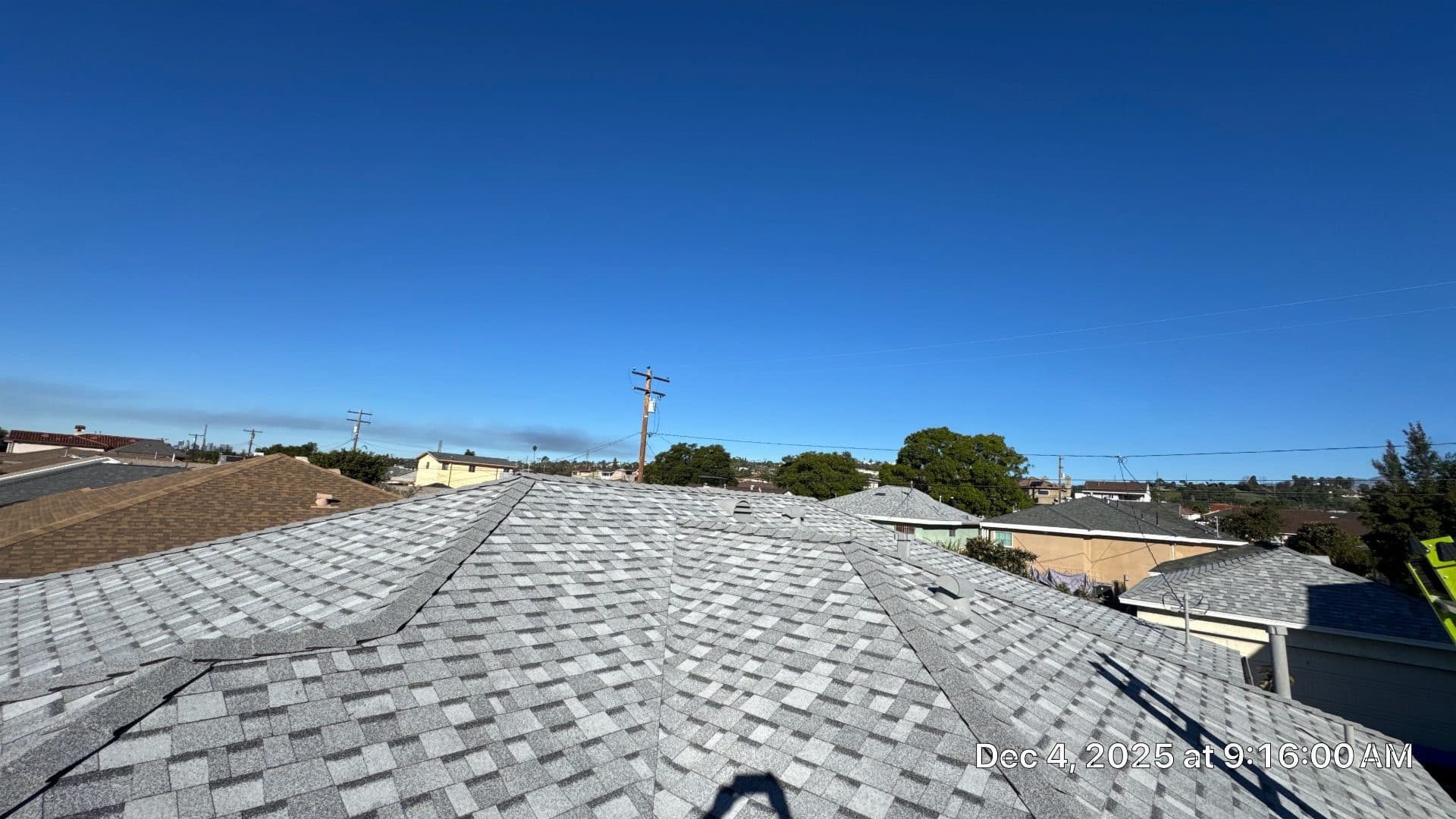 Newly installed gray asphalt shingle roof, hip style, residential neighborhood | Roof Replacement Inc Newly installed gray asphalt shingle roof, hip style, residential neighborhood — Roof Replacement Inc