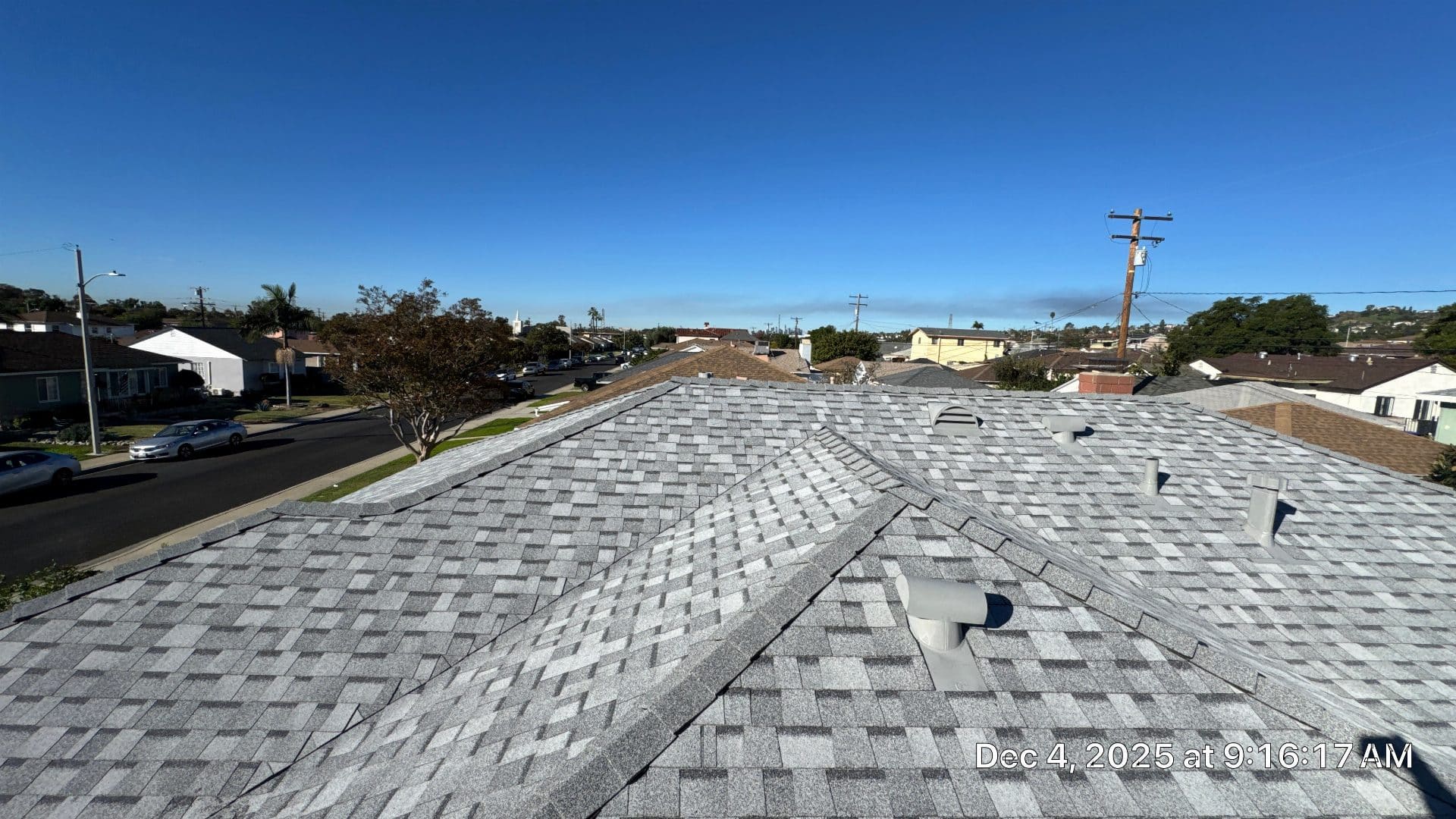 Gray asphalt shingle roof with pipe vents and hip ridges — Roof Replacement Inc