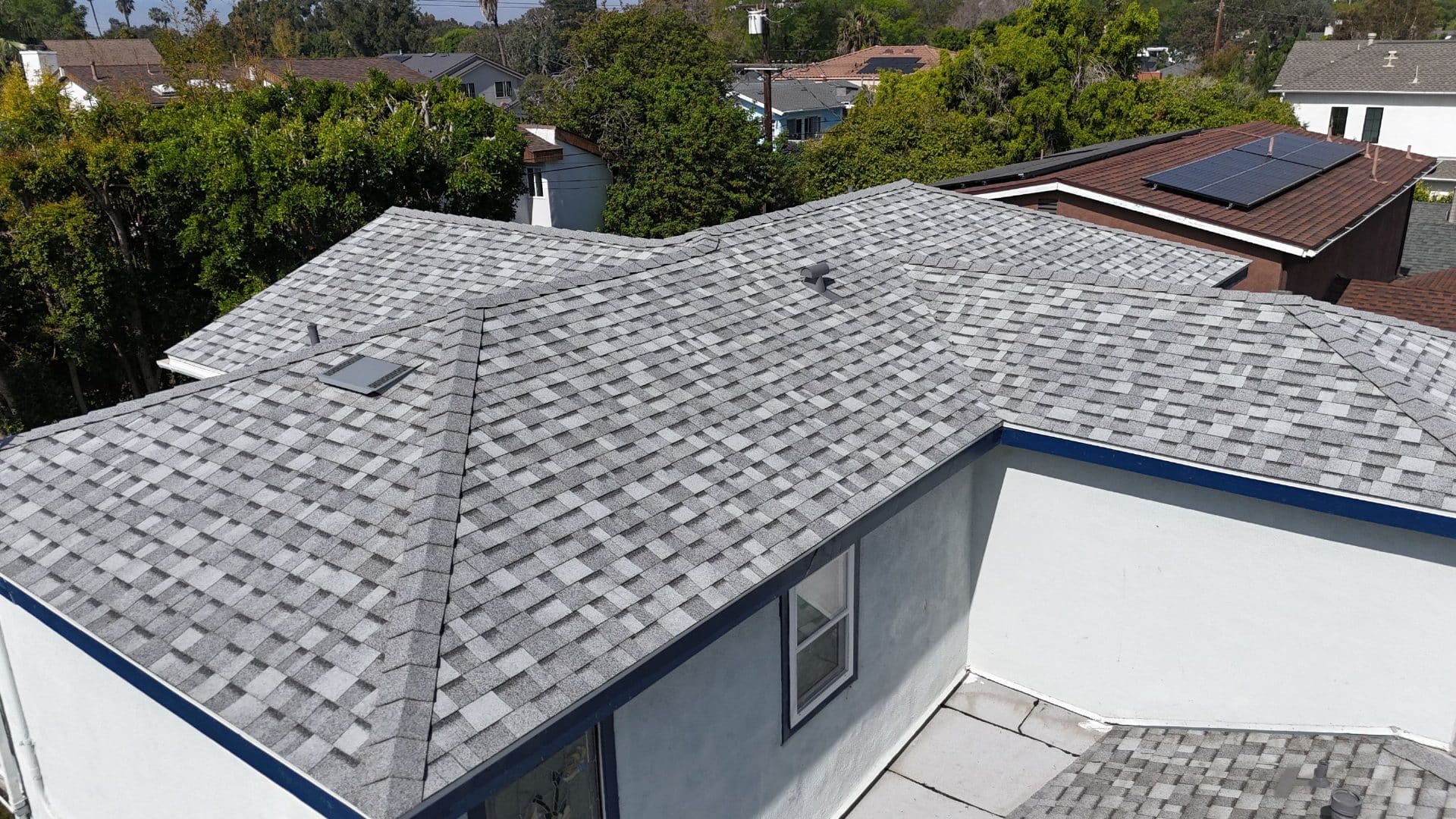 New gray asphalt shingle hip roof with skylight and vents | Roof Replacement Inc New gray asphalt shingle hip roof with skylight and vents — Roof Replacement Inc