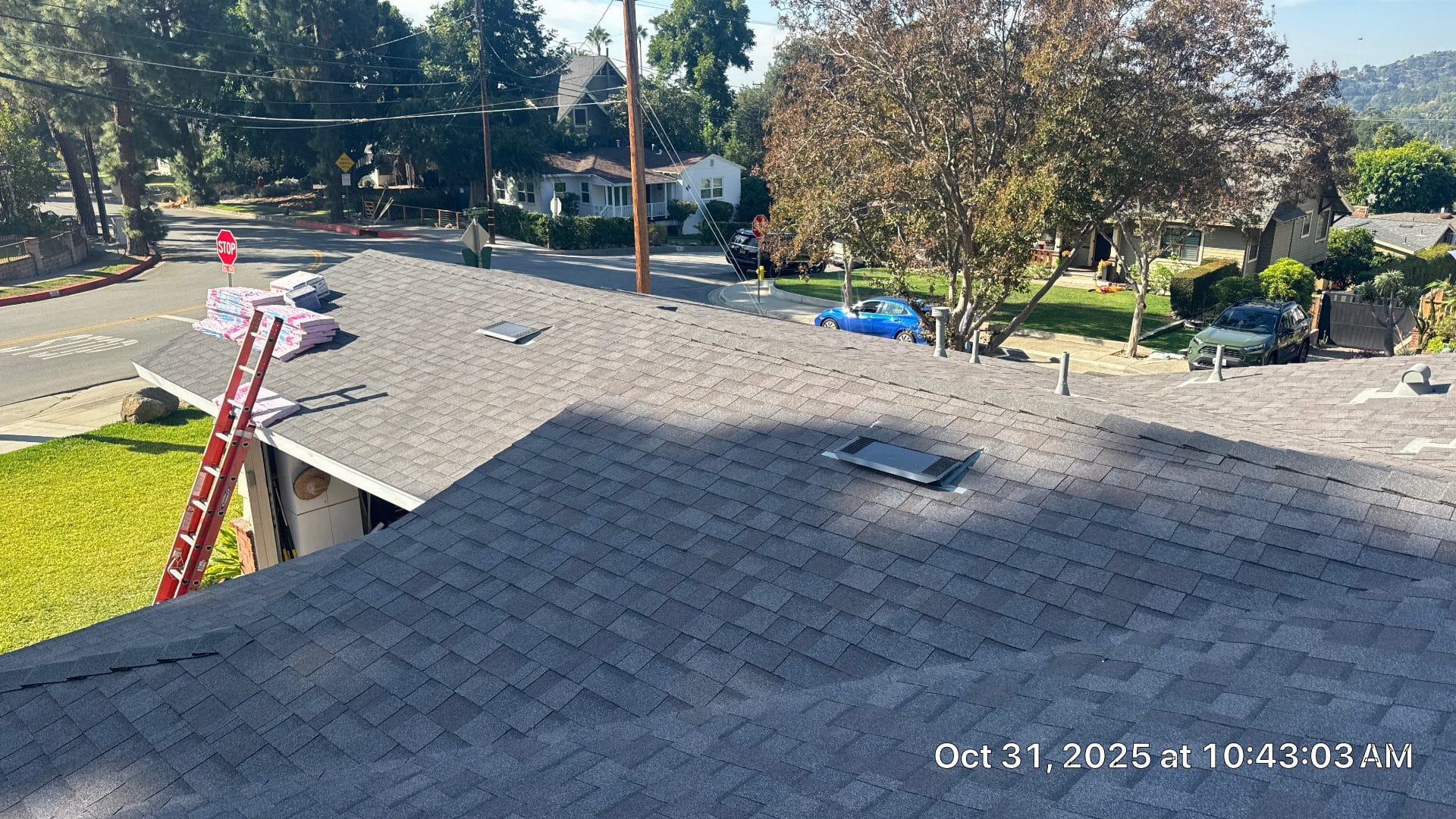 Newly installed gray asphalt shingles, roof vents, ladder, shingle bundles staged | Roof Replacement Inc Newly installed gray asphalt shingles, roof vents, ladder, shingle bundles staged — Roof Replacement Inc