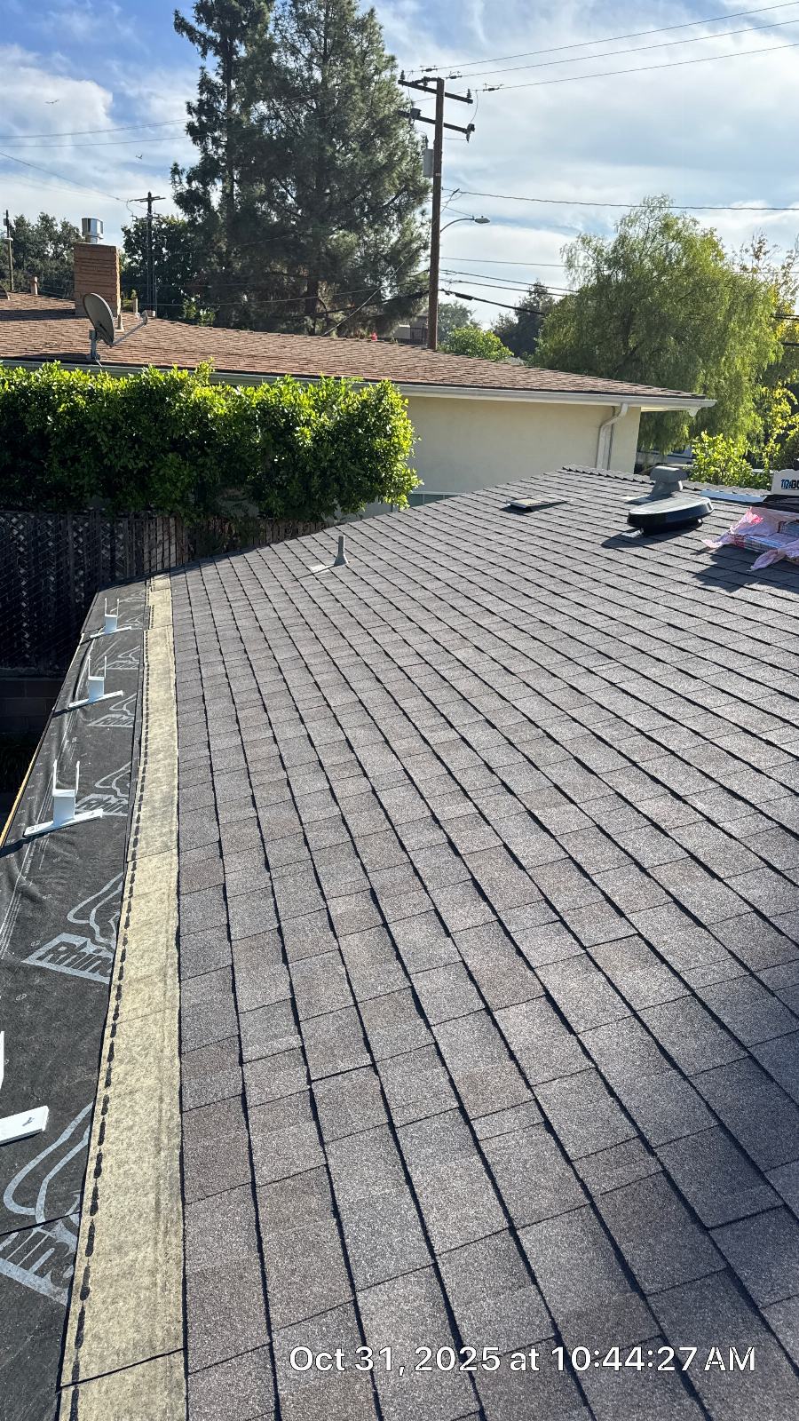 New gray asphalt shingles installed on sloped roof with skylight vents | Roof Replacement Inc New gray asphalt shingles installed on sloped roof with skylight vents — Roof Replacement Inc