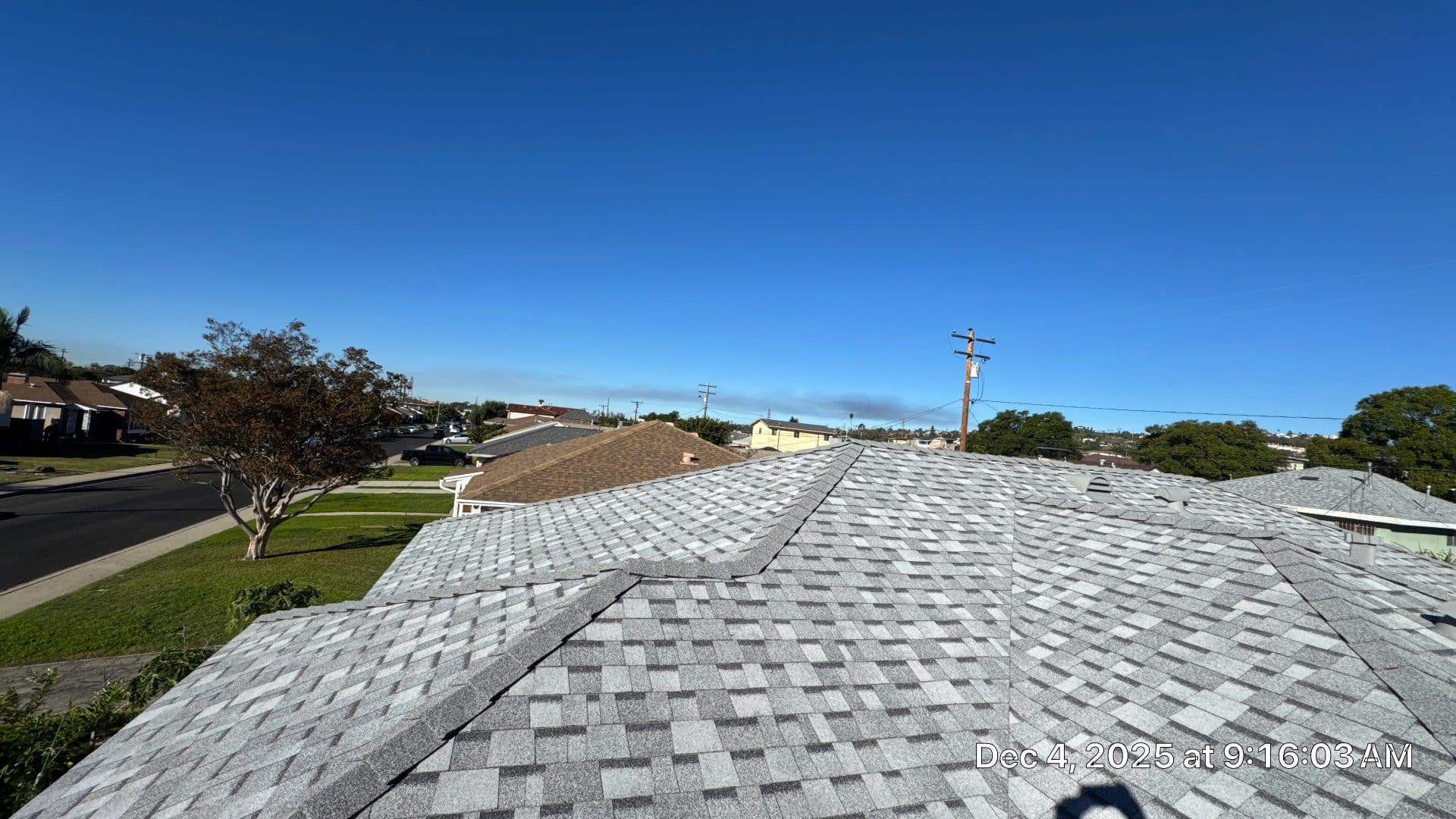 New gray asphalt shingle roof, residential neighborhood background | Roof Replacement Inc New gray asphalt shingle roof, residential neighborhood background — Roof Replacement Inc