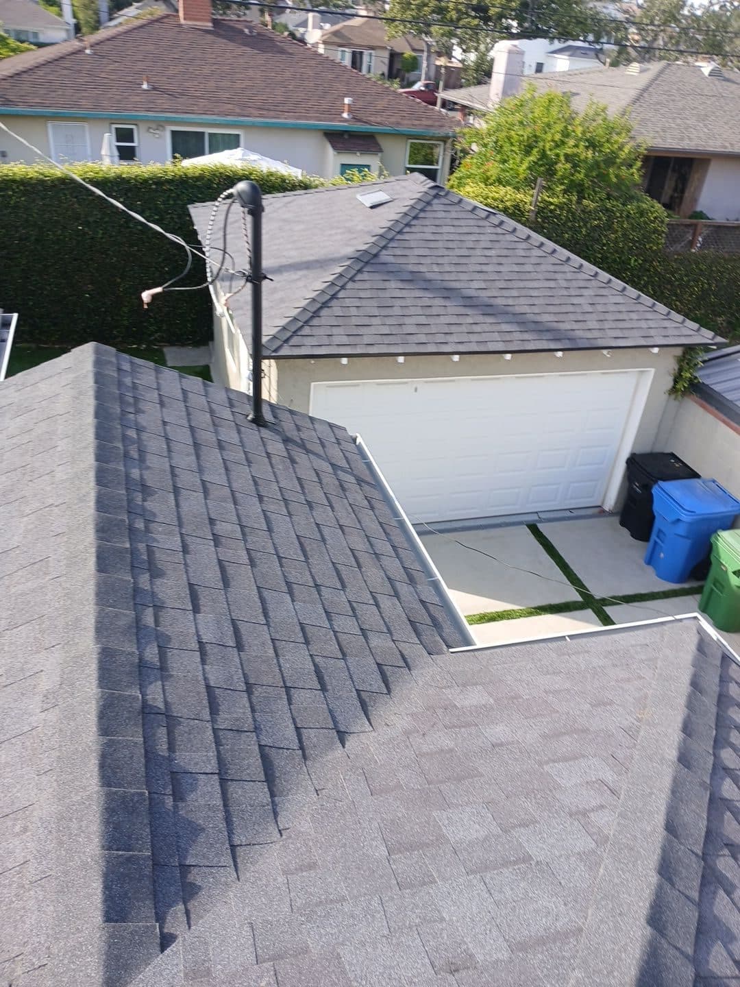 Gray asphalt shingle roof with pipe vent, detached garage below | Roof Replacement Inc Gray asphalt shingle roof with pipe vent, detached garage below — Roof Replacement Inc