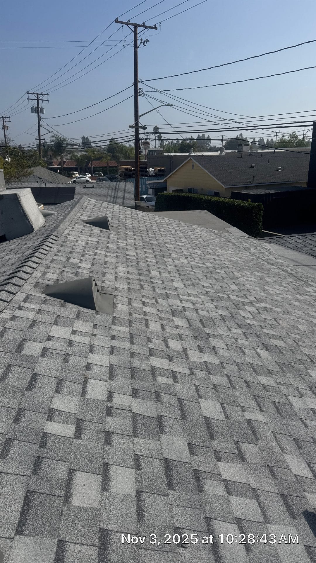 Gray asphalt shingle roof with two open roof vents installed | Roof Replacement Inc Gray asphalt shingle roof with two open roof vents installed — Roof Replacement Inc