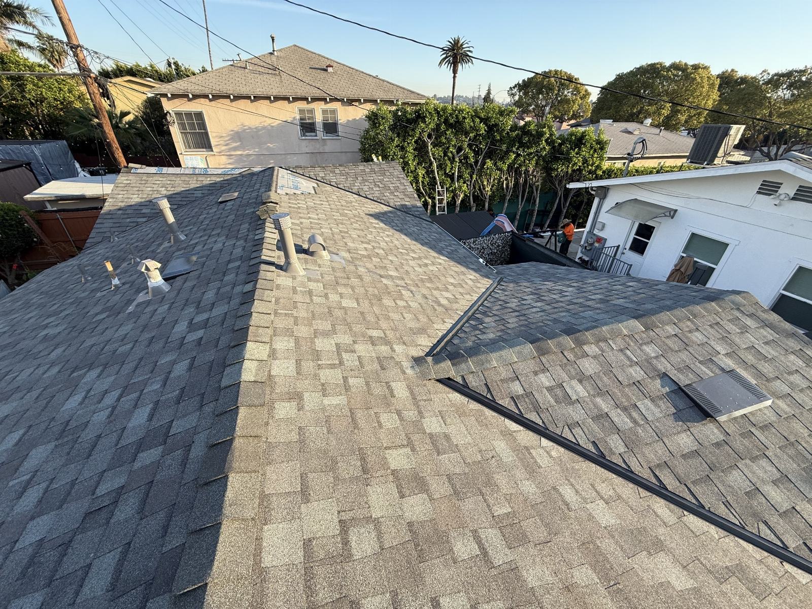 Newly installed gray asphalt shingle roof with pipe vents and valley flashing | Roof Replacement Inc newly installed gray asphalt shingle roof with pipe vents and valley flashing — Roof Replacement Inc
