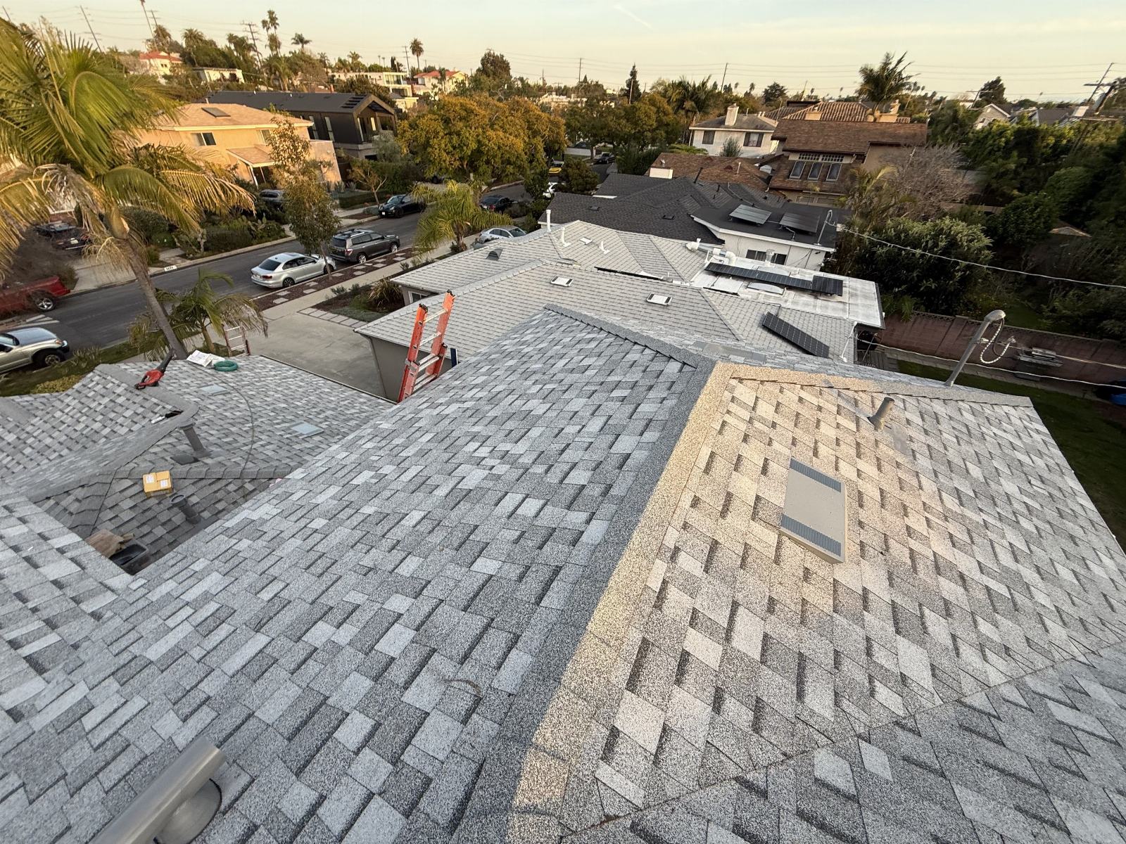 Aerial view of completed gray asphalt shingle re-roof with skylight and ladder | Roof Replacement Inc Aerial view of completed gray asphalt shingle re-roof with skylight and ladder — Roof Replacement Inc