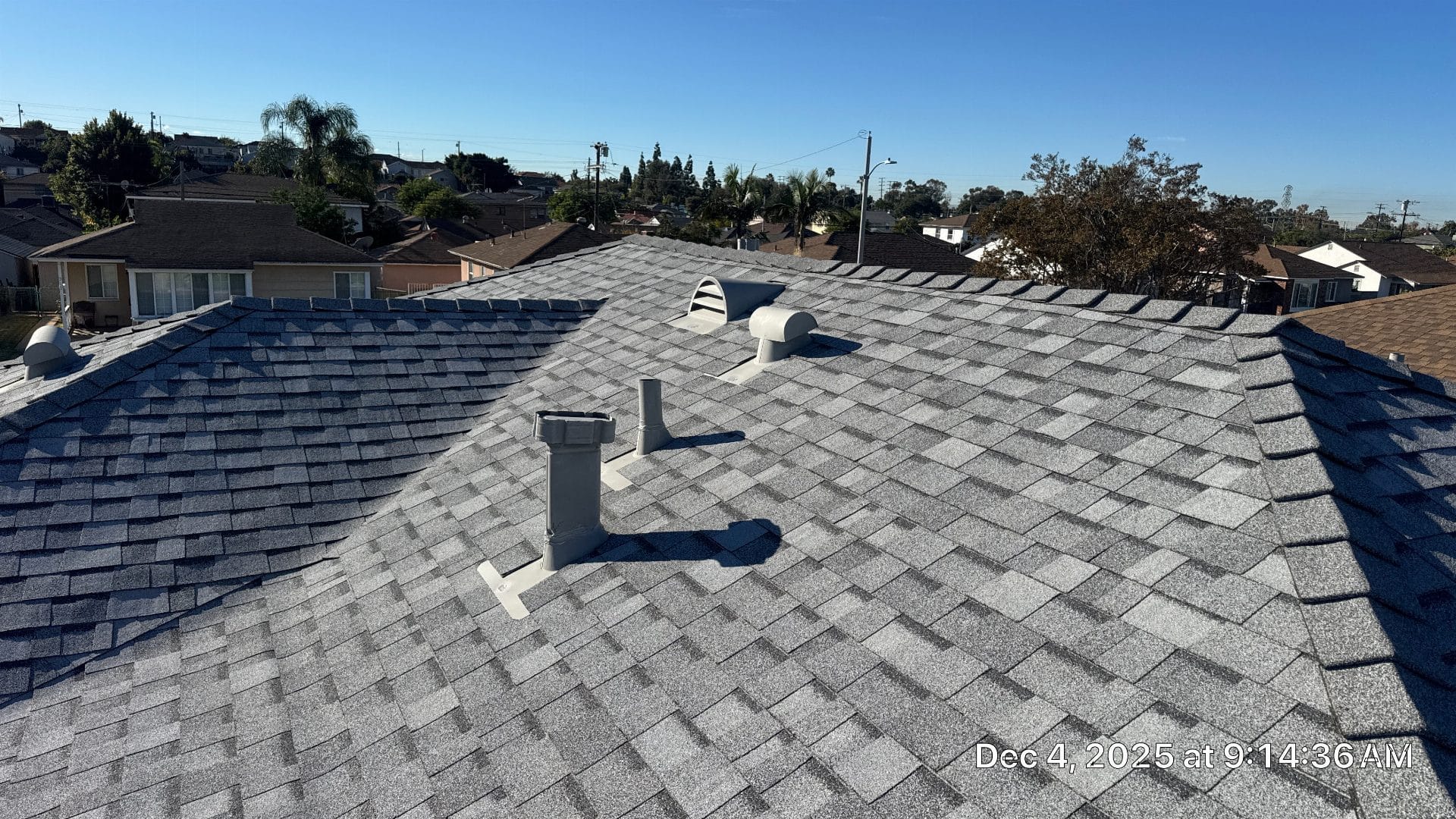 New grey asphalt shingle roof with pipe boots and exhaust vents | Roof Replacement Inc New grey asphalt shingle roof with pipe boots and exhaust vents — Roof Replacement Inc