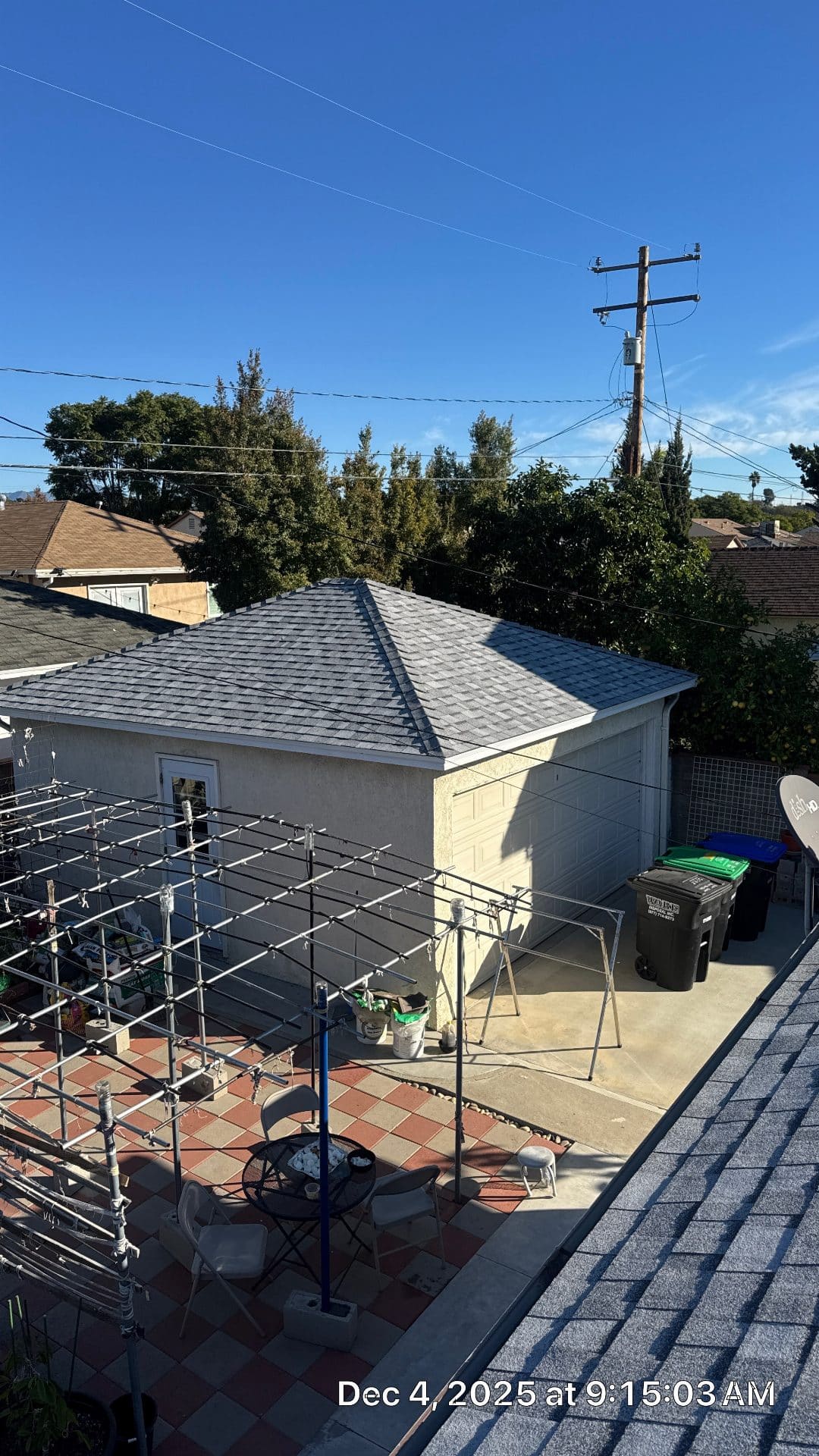 Completed hip roof with grey asphalt shingles over detached garage | Roof Replacement Inc Completed hip roof with grey asphalt shingles over detached garage — Roof Replacement Inc