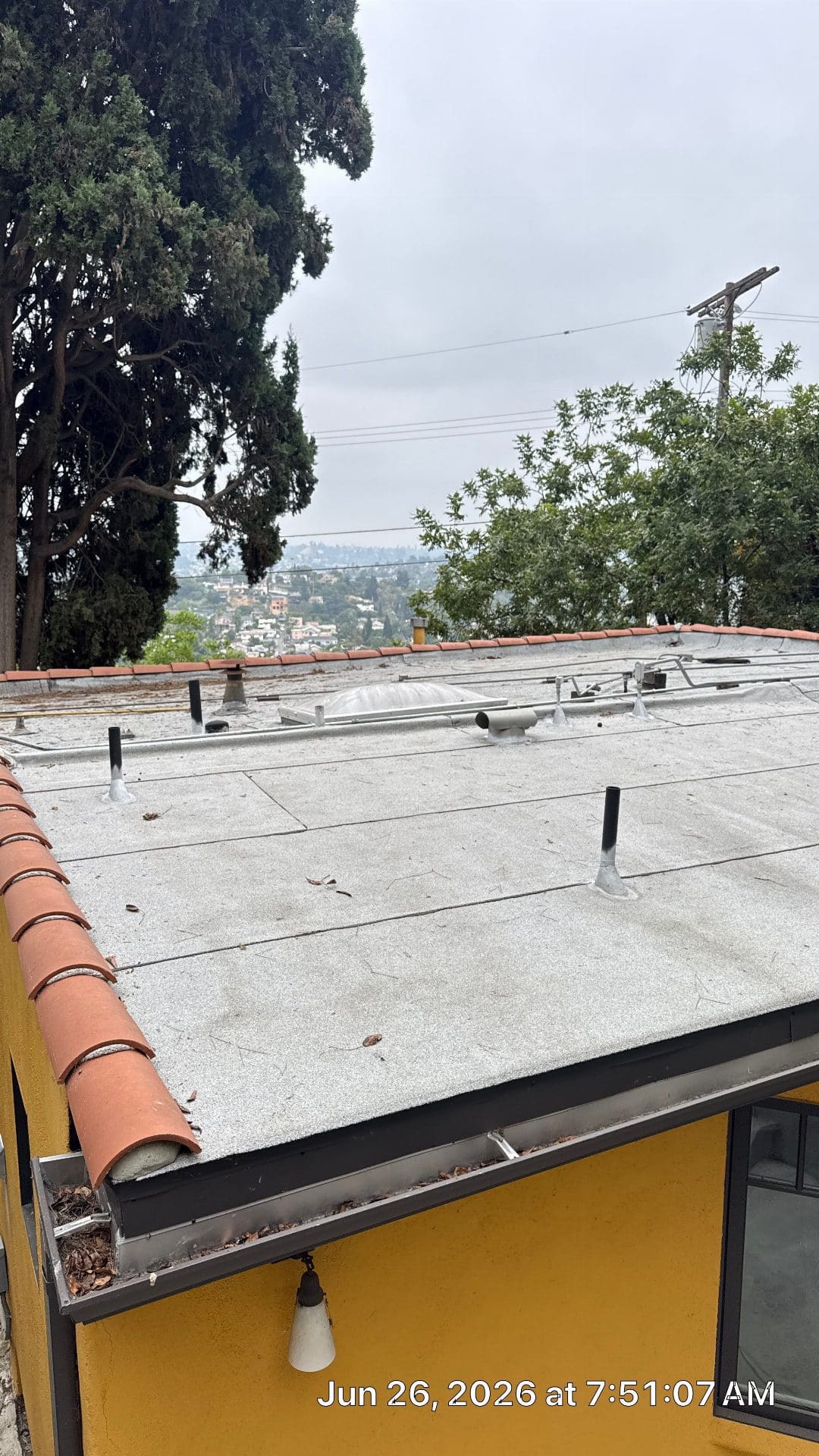 Flat roof with built-up membrane, pipe penetrations, and skylight in North Hollywood | Roof Replacement Inc flat roof with built-up membrane, pipe penetrations, and skylight — North Hollywood — Roof Replacement Inc