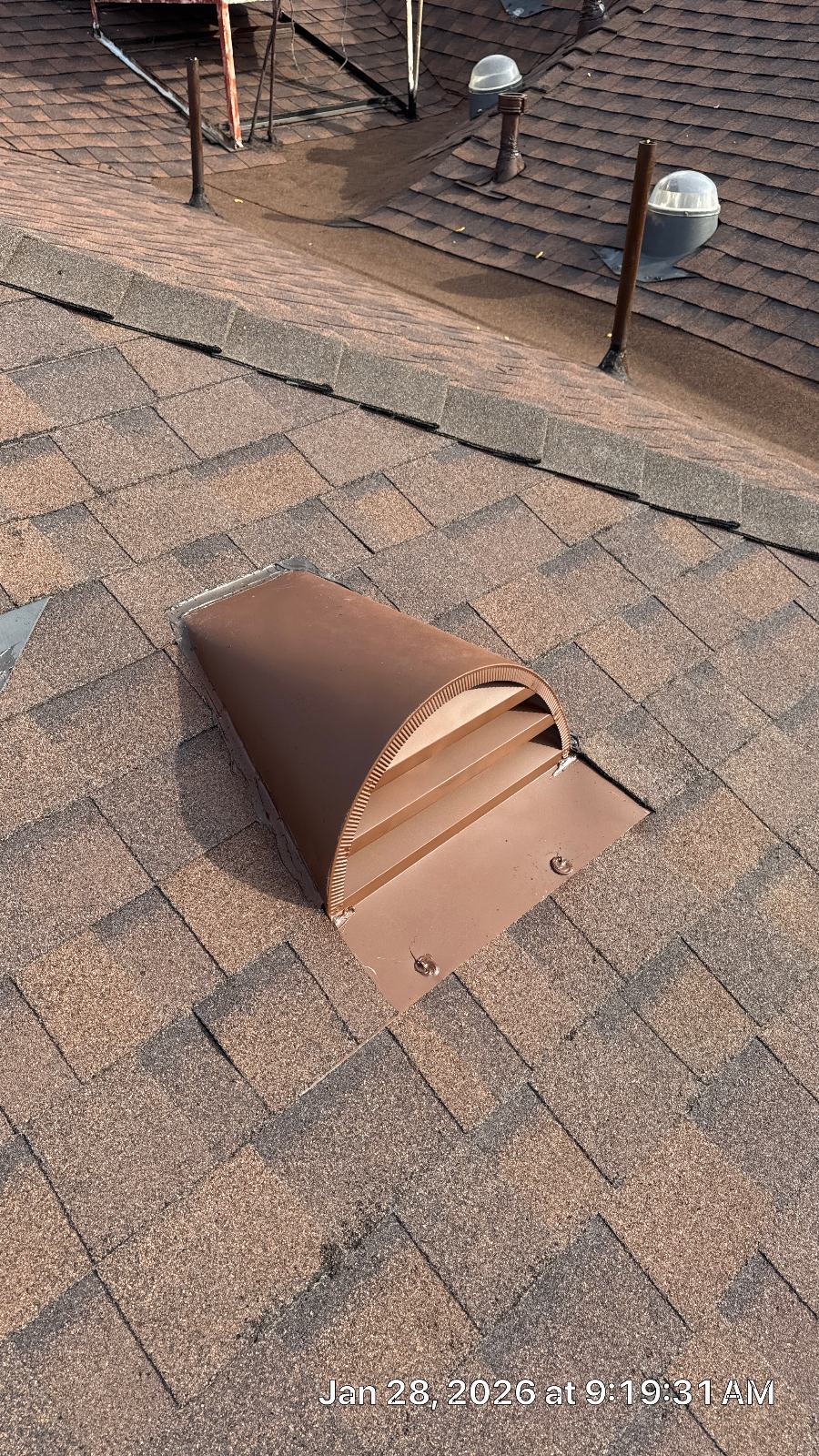 Brown metal exhaust vent cap installed on asphalt shingle roof | Roof Replacement Inc Brown metal exhaust vent cap installed on asphalt shingle roof — Roof Replacement Inc