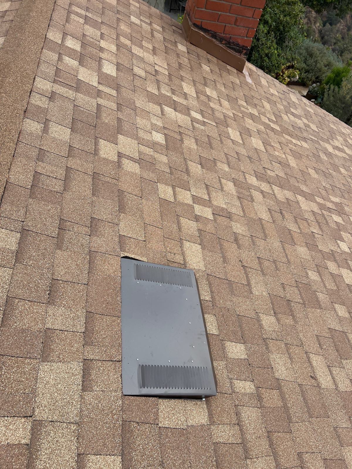Metal roof vent installed on tan asphalt shingle roof in Altadena | Roof Replacement Inc metal roof vent installed on tan asphalt shingle roof — Altadena — Roof Replacement Inc