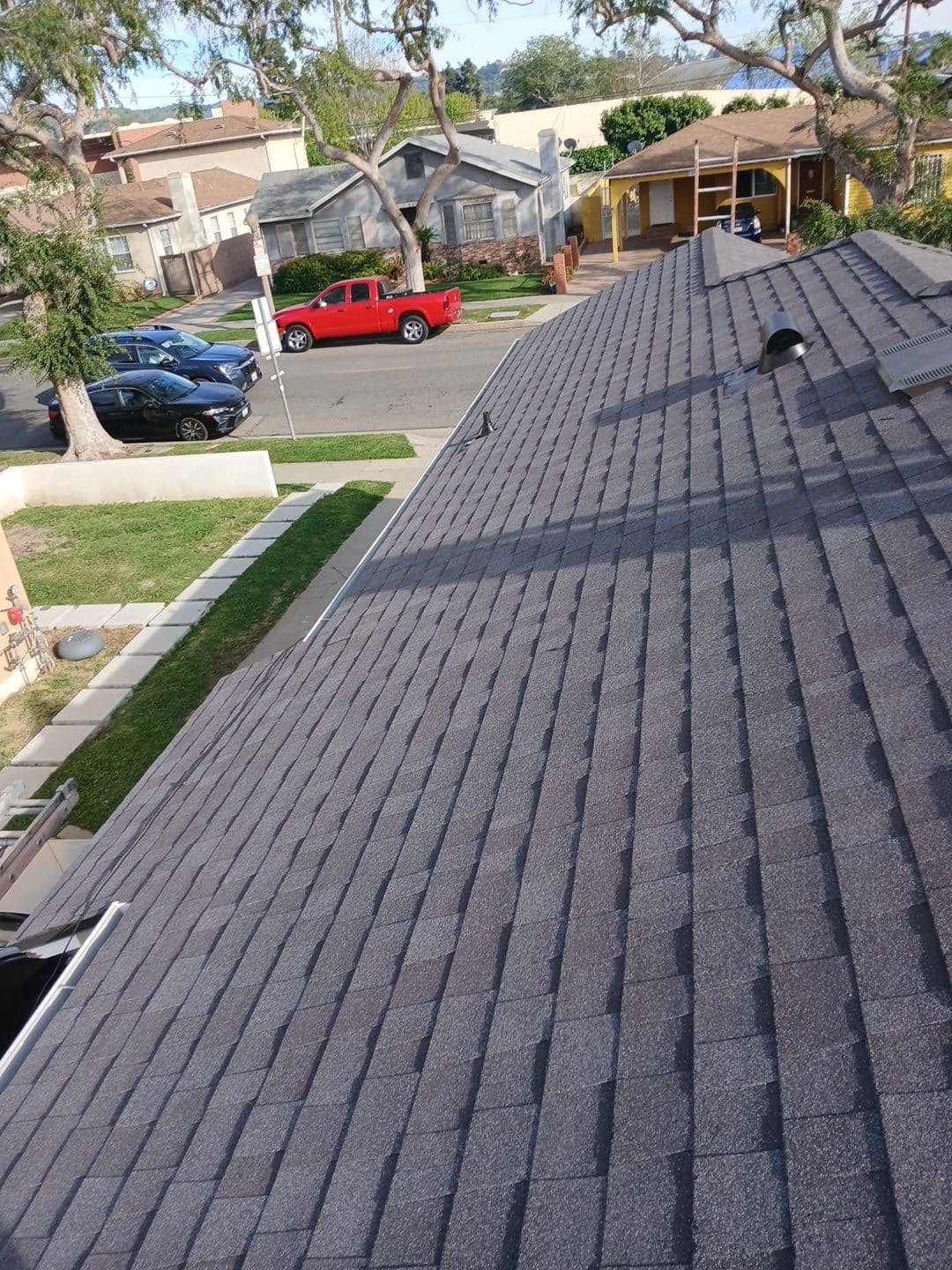 New dark gray asphalt shingle roof with vent pipe and ridge cap | Roof Replacement Inc New dark gray asphalt shingle roof with vent pipe and ridge cap — Roof Replacement Inc