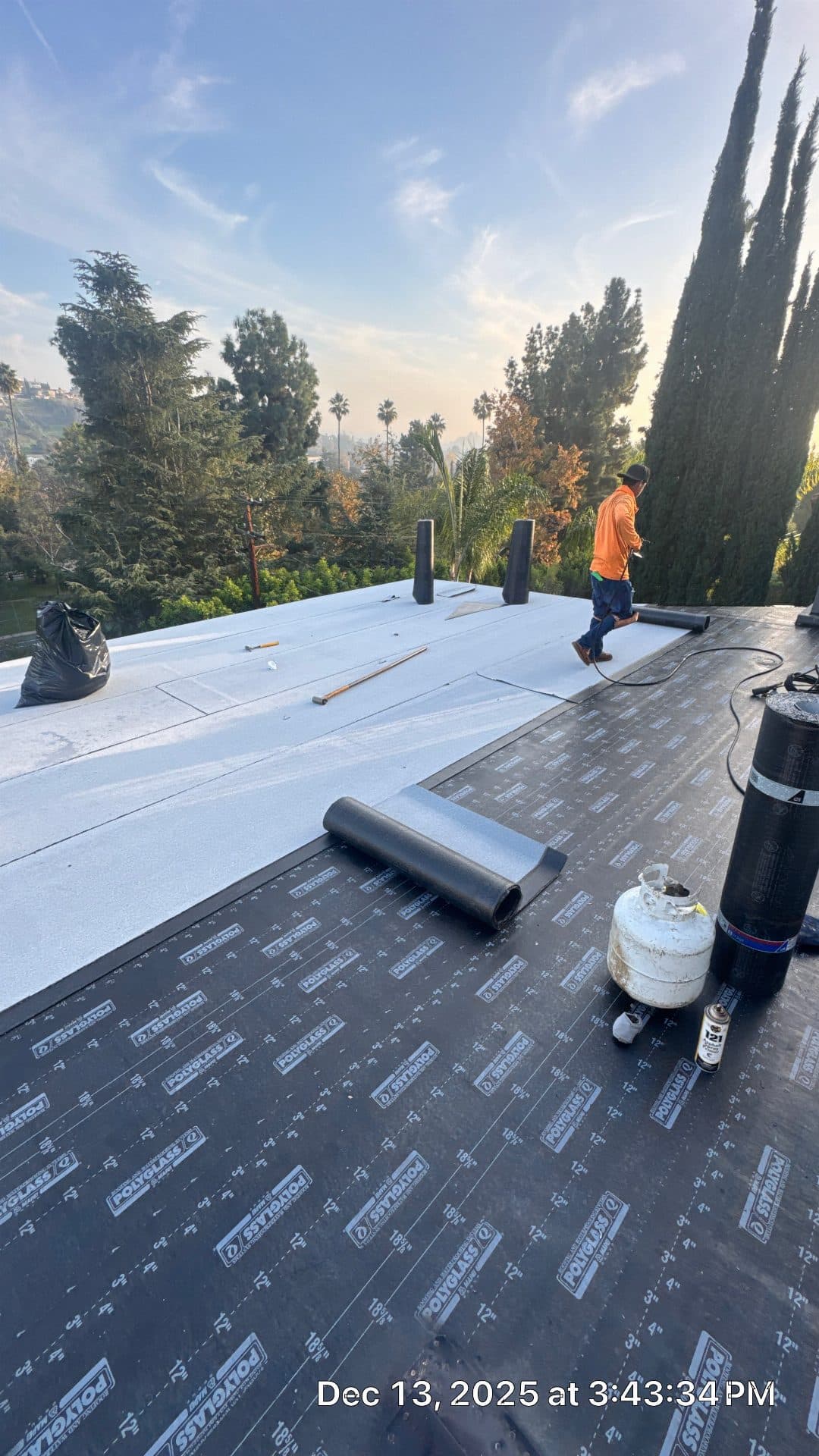 roofer installing Polyglass modified bitumen and white TPO membrane flat roof — Glendale — Roof Replacement Inc
