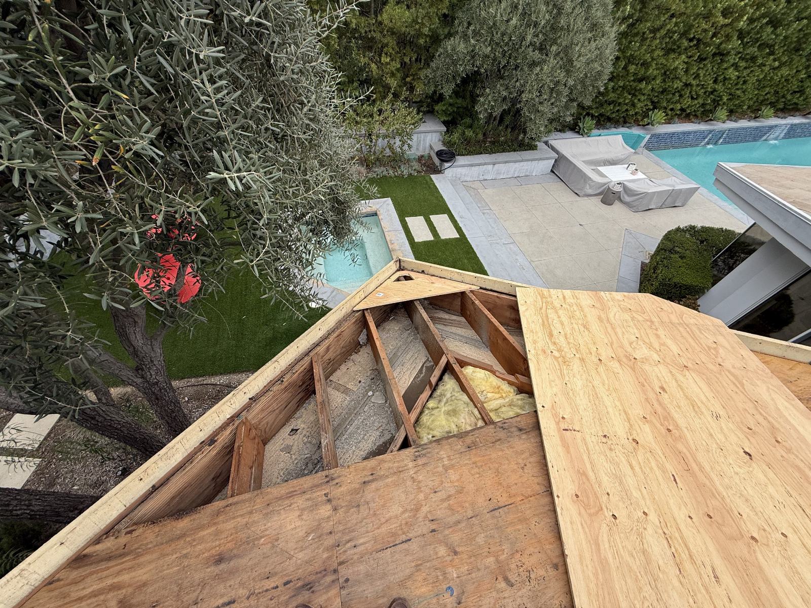 Roof deck plywood installation over exposed rafters and fiberglass insulation | Roof Replacement Inc Roof deck plywood installation over exposed rafters and fiberglass insulation — Roof Replacement Inc