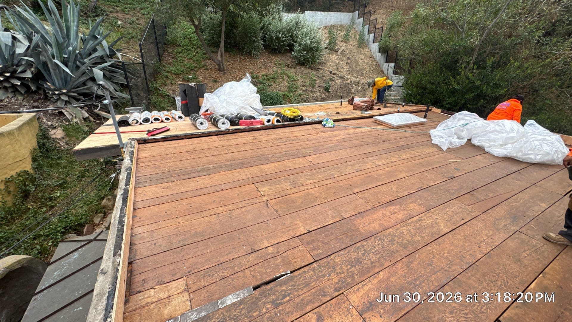 Workers replacing flat roof deck with rolled roofing materials staged in North Hollywood | Roof Replacement Inc workers replacing flat roof deck with rolled roofing materials staged — North Hollywood — Roof Replacement Inc