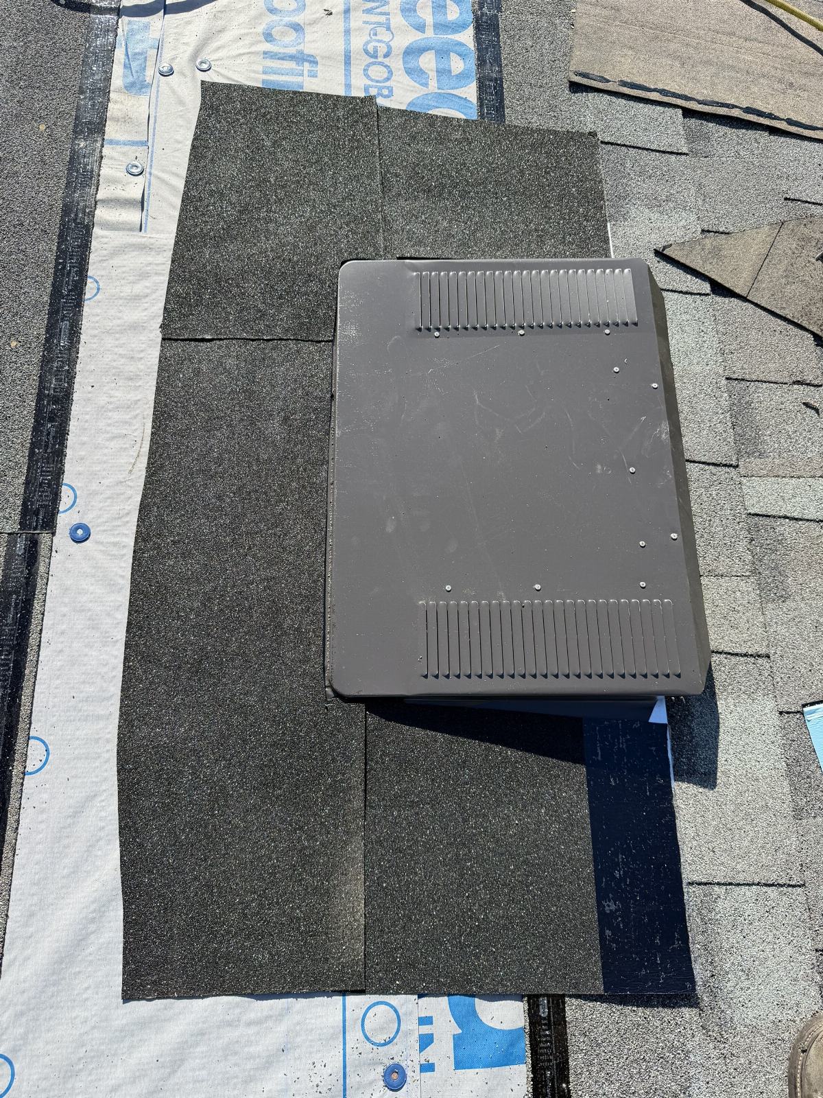 Roof vent installed on black asphalt shingles with underlayment | Roof Replacement Inc roof vent installed on black asphalt shingles with underlayment — Roof Replacement Inc