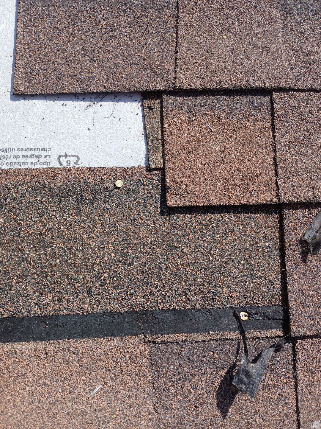 Asphalt shingles partially installed near roof edge with underlayment exposed | Roof Replacement Inc Asphalt shingles partially installed near roof edge with underlayment exposed — Roof Replacement Inc