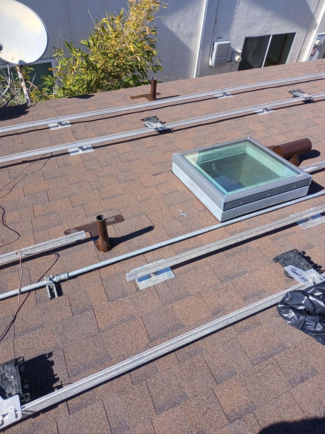 Asphalt shingle roof with solar rail mounting system and skylight | Roof Replacement Inc Asphalt shingle roof with solar rail mounting system and skylight — Roof Replacement Inc