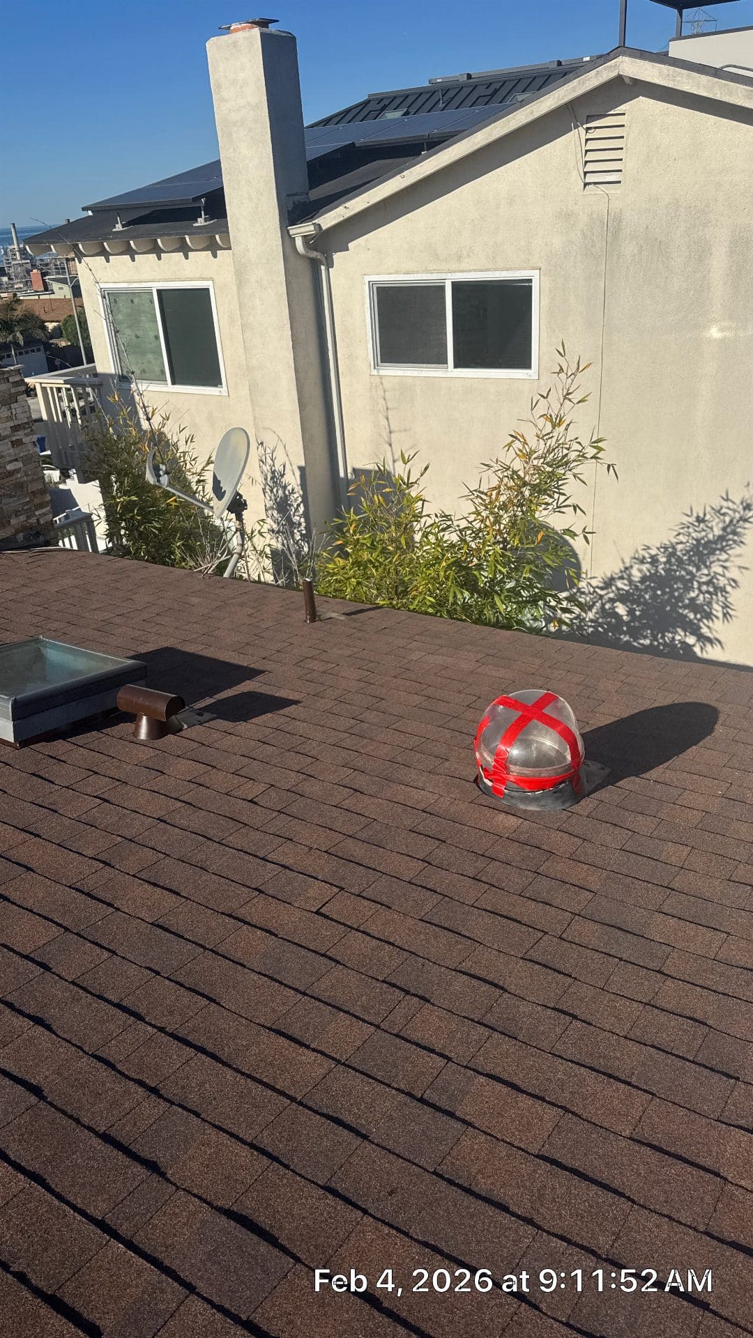 Asphalt shingle roof with tubular skylight dome taped red and flat skylight — Roof Replacement Inc