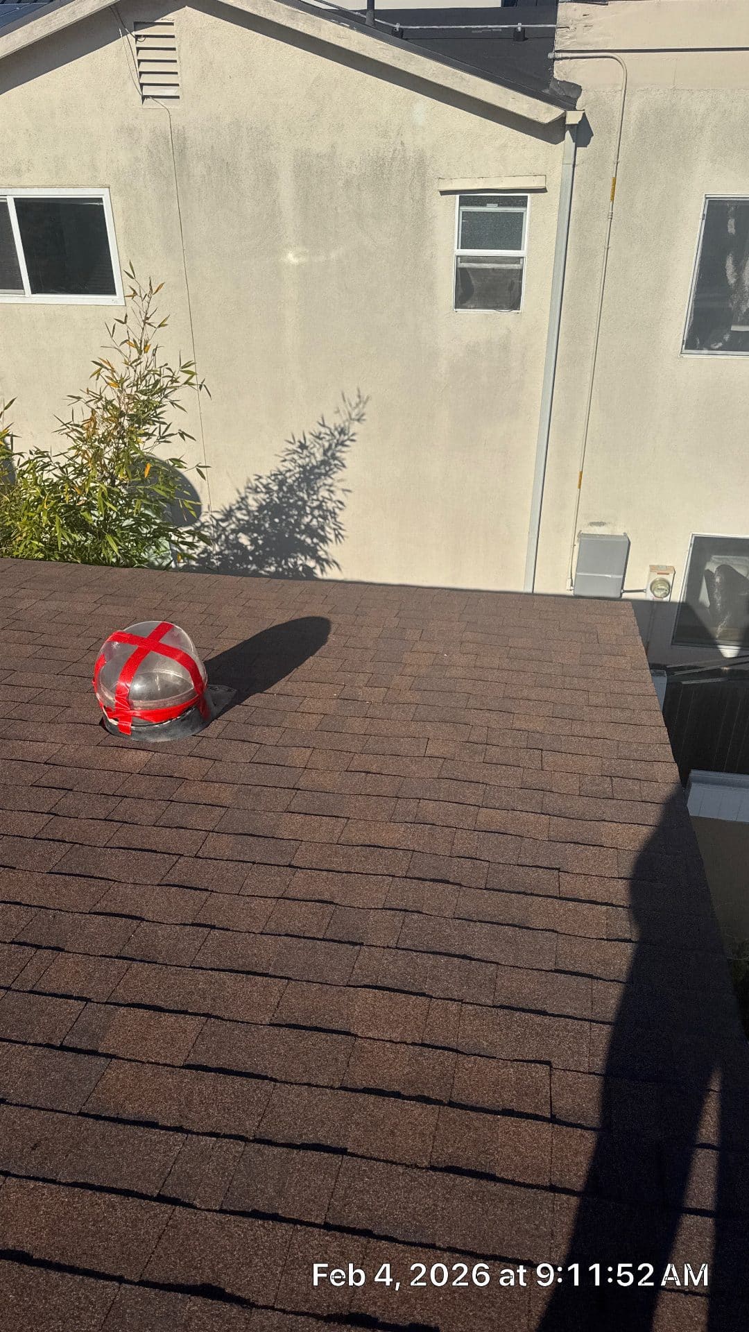 Asphalt shingle roof with tubular skylight dome taped red — Roof Replacement Inc