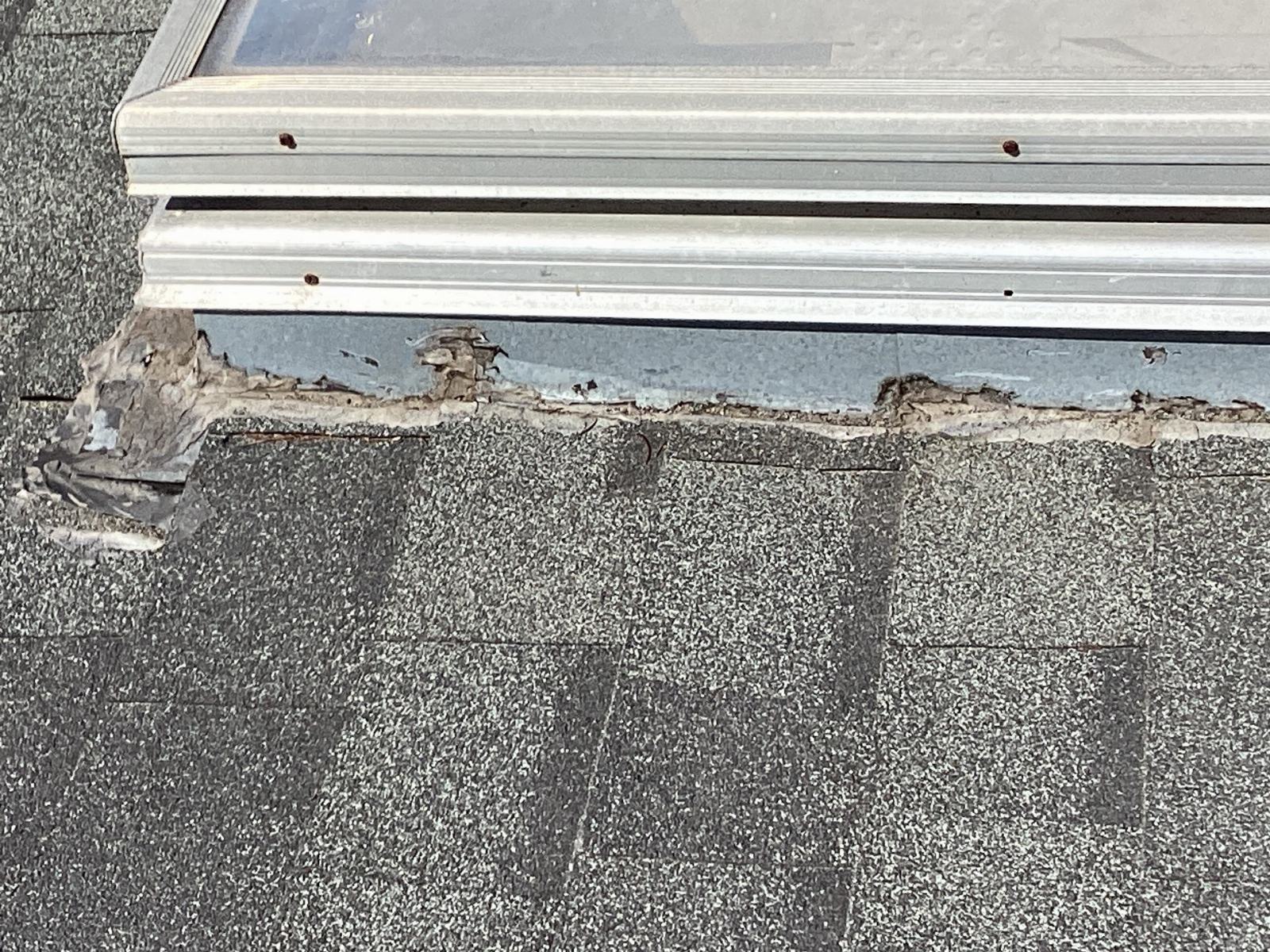 Deteriorated caulk sealant along skylight bottom flashing on asphalt shingles in Calabasas | Roof Replacement Inc deteriorated caulk sealant along skylight bottom flashing on asphalt shingles — Calabasas — Roof Replacement Inc