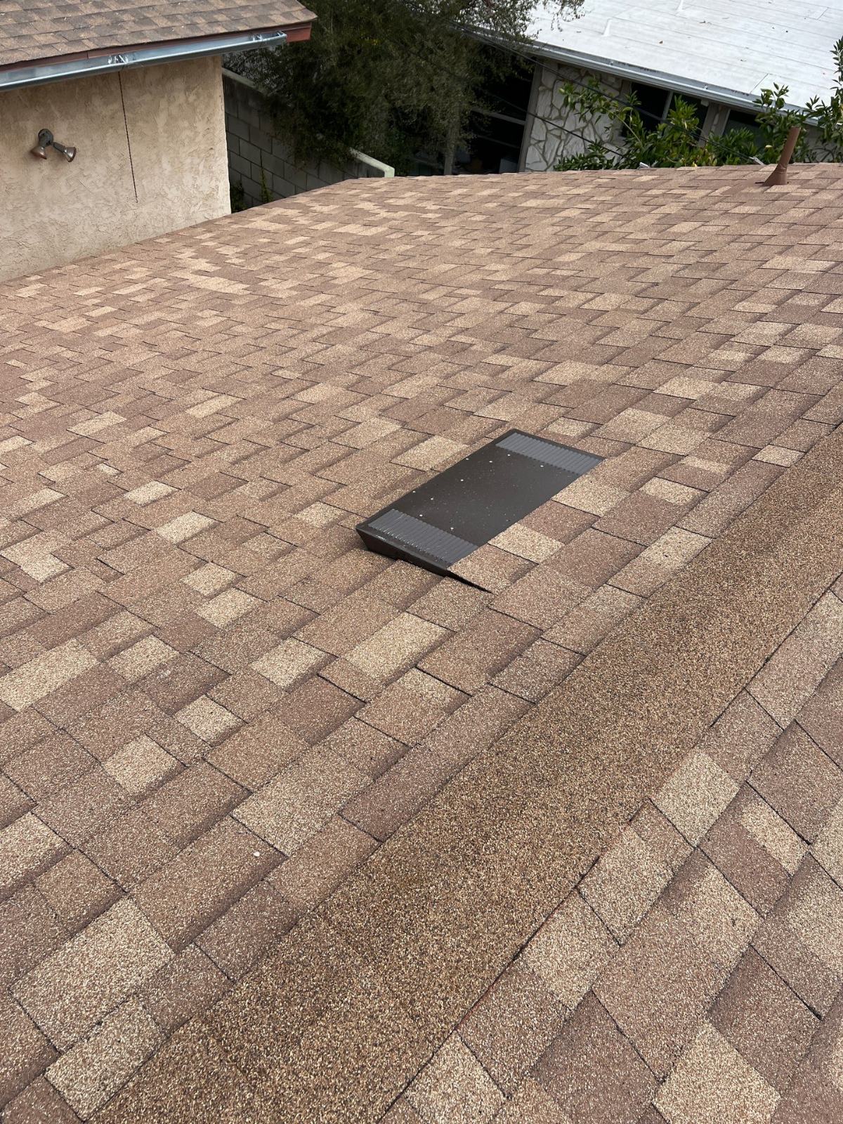 solar attic vent installed on brown asphalt shingle roof — Altadena — Roof Replacement Inc