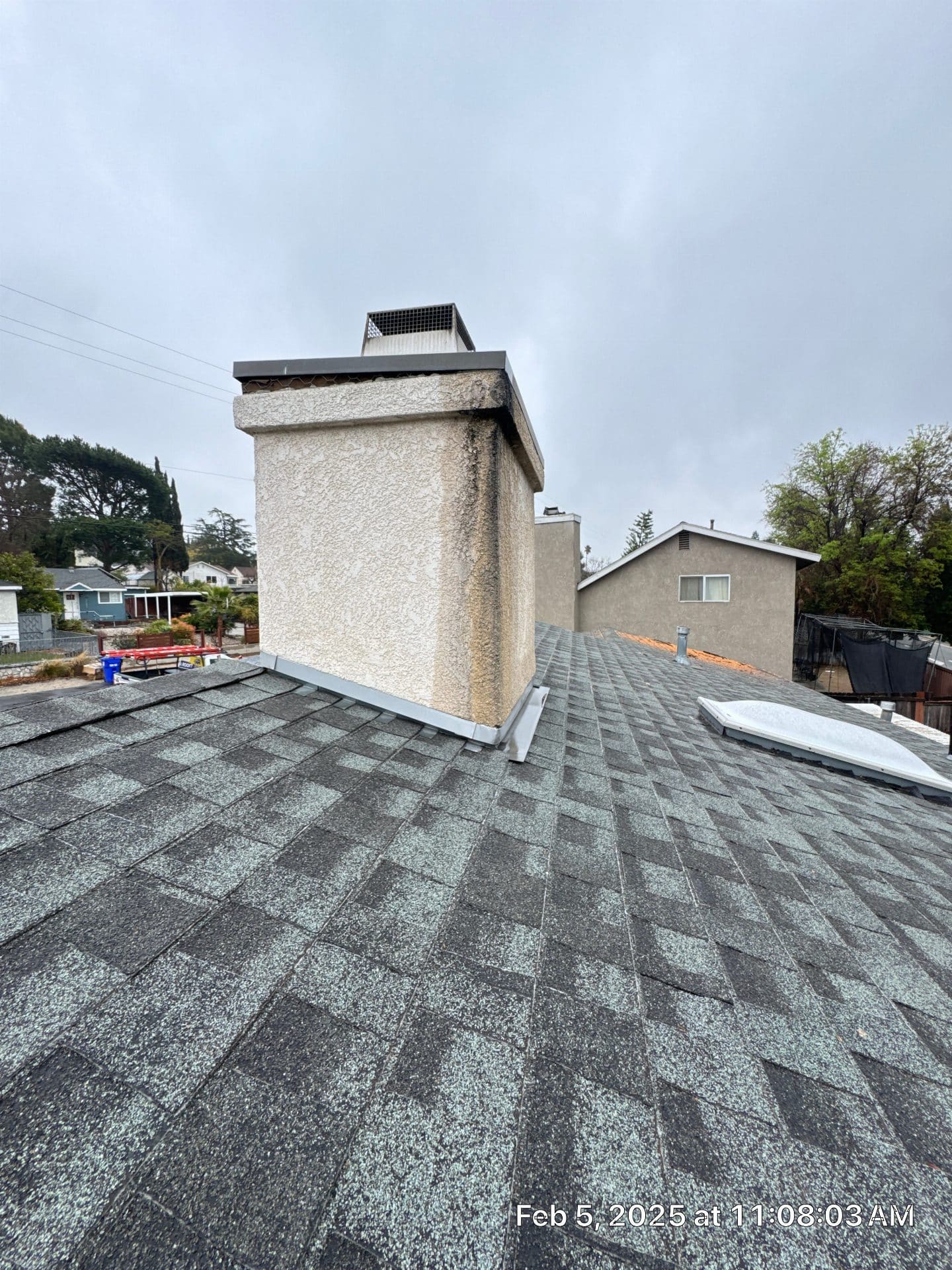 stucco chimney with cap on gray asphalt shingle roof — La Crescenta-Montrose — Roof Replacement Inc