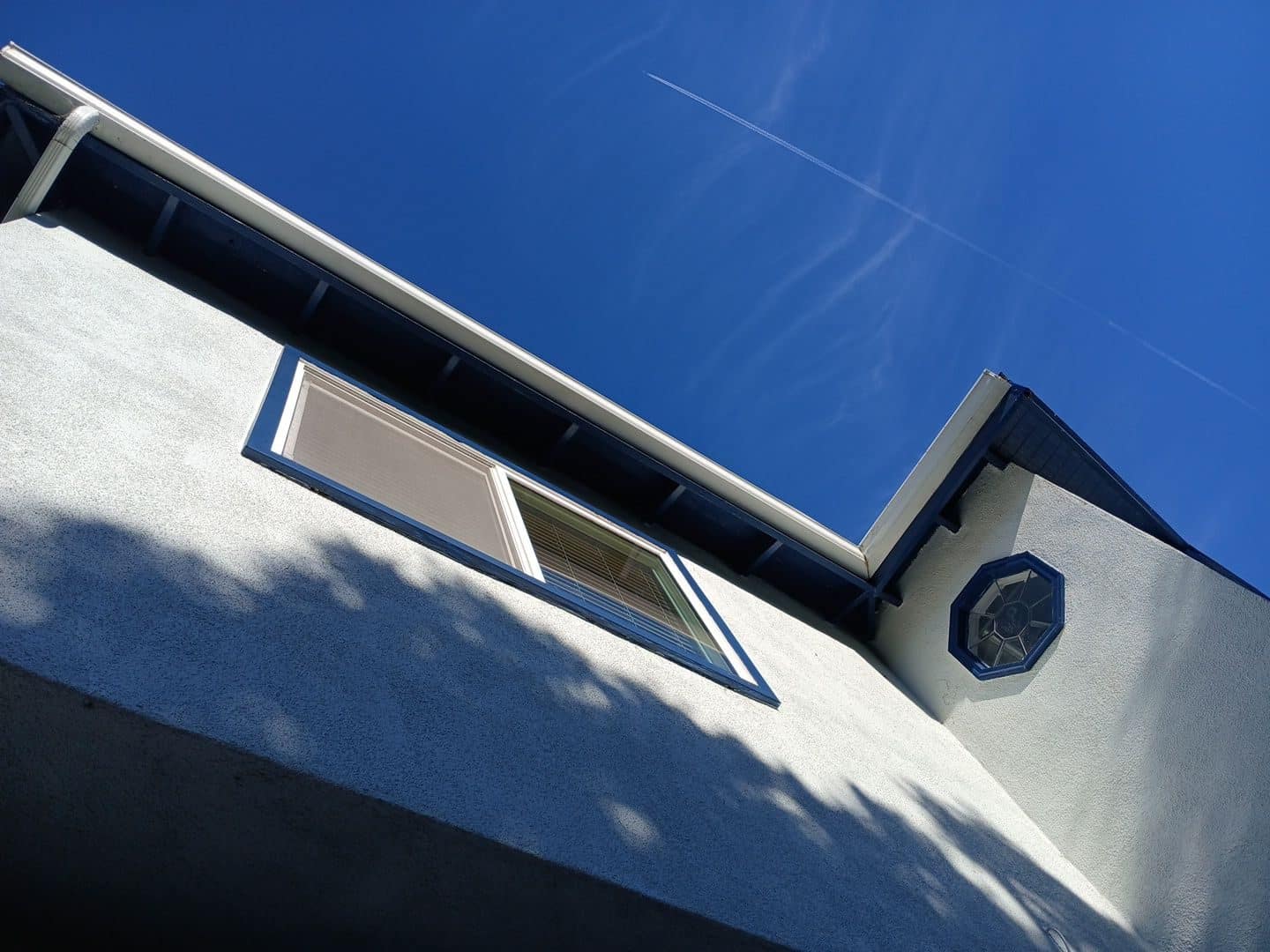 Stucco gable end, fascia, soffit, rectangular window, octagonal vent | Roof Replacement Inc Stucco gable end, fascia, soffit, rectangular window, octagonal vent — Roof Replacement Inc